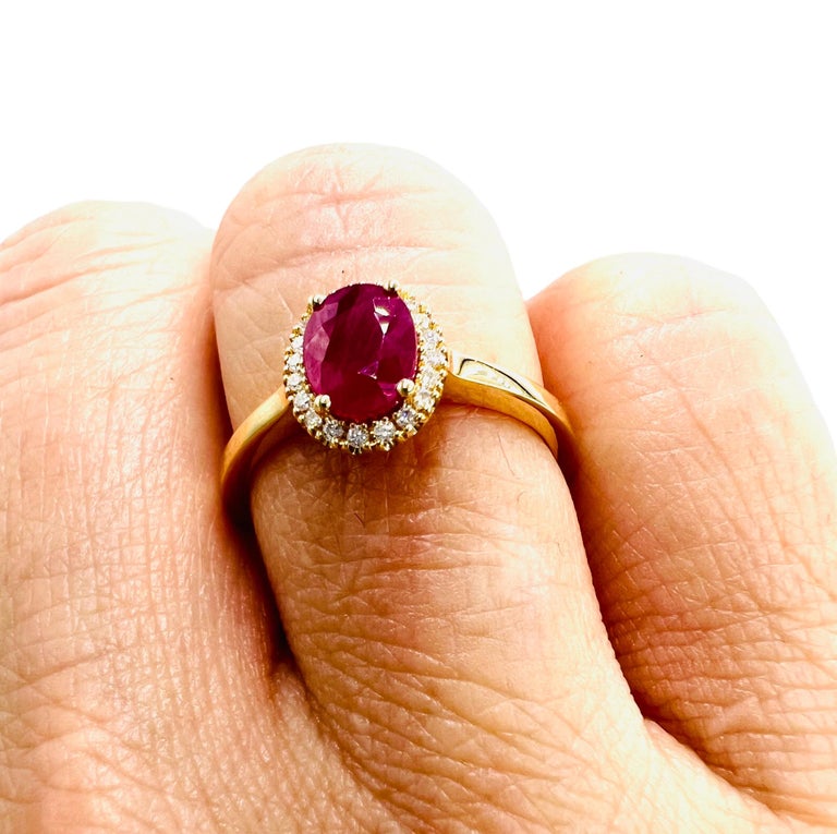 18Carat Gold Ring, Set with a Ruby in Its Center, Paved with
