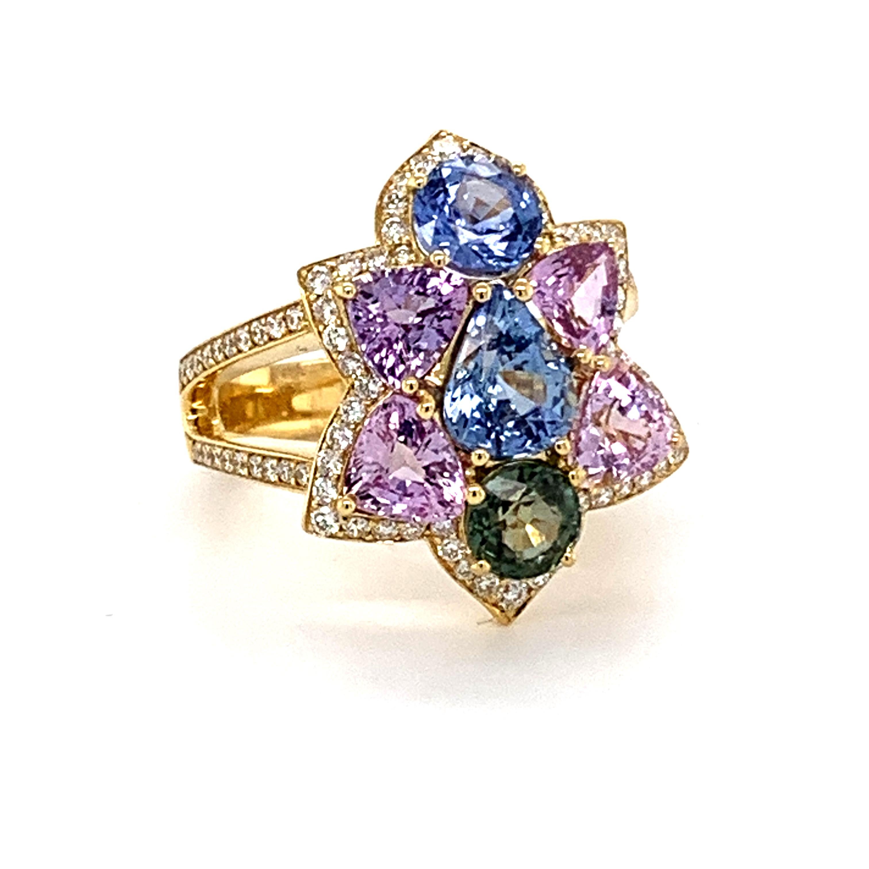 Unusual and one of the kind engagement 18 karat yellow gold cluster ring set with ice cream colors non heated natural sapphires,
blue, pink, lavender and green.
5.36 carats in weight and .57 carats in pave diamonds FG color VVS1 clarity.