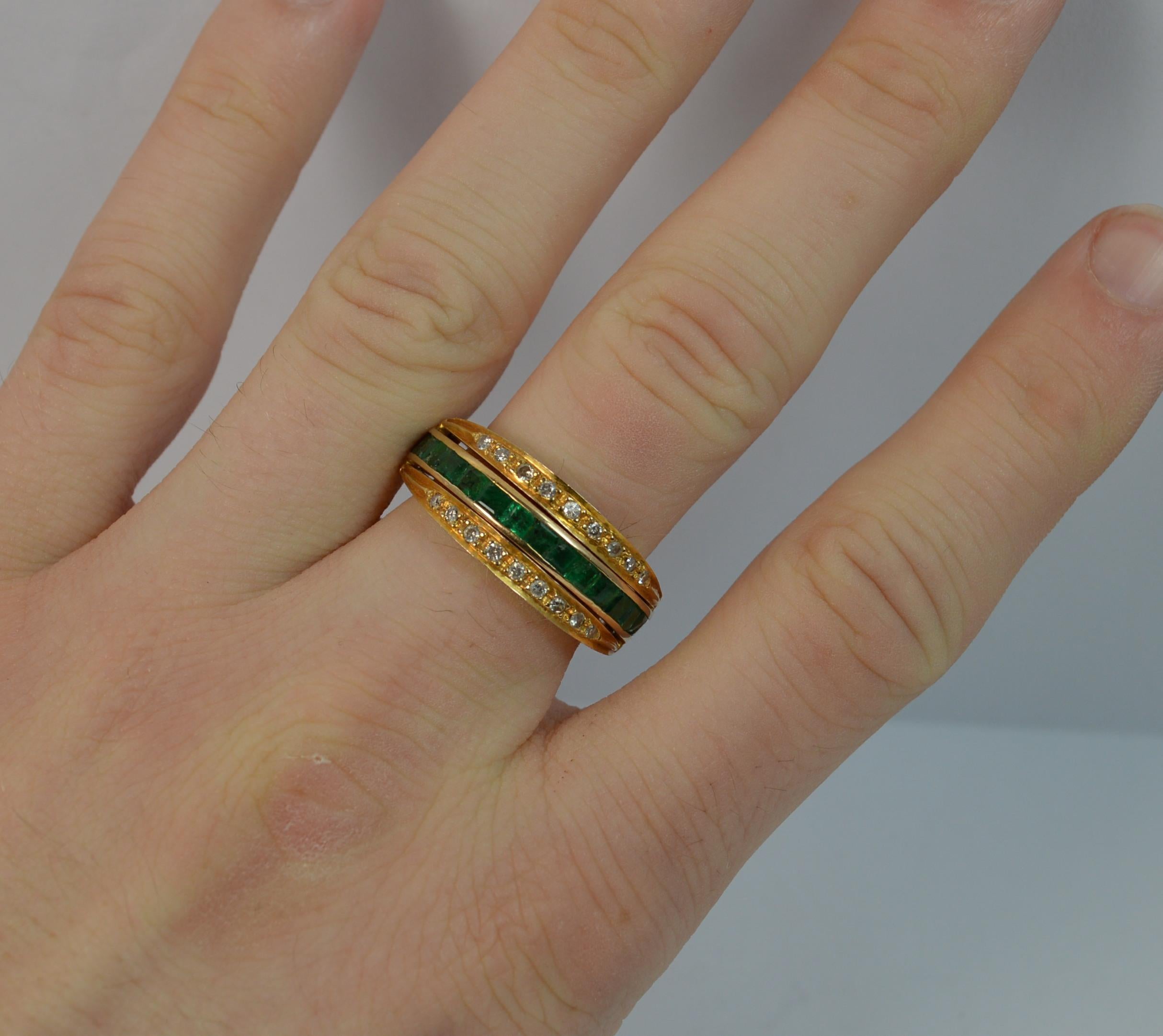 A stunning full eternity Day / Night ring.

Solid 18 carat yellow gold example.

Designed with the central band of princess cut rubies to one half and emeralds the other. There are two hinged sections with round cut diamonds, one to each side. 18