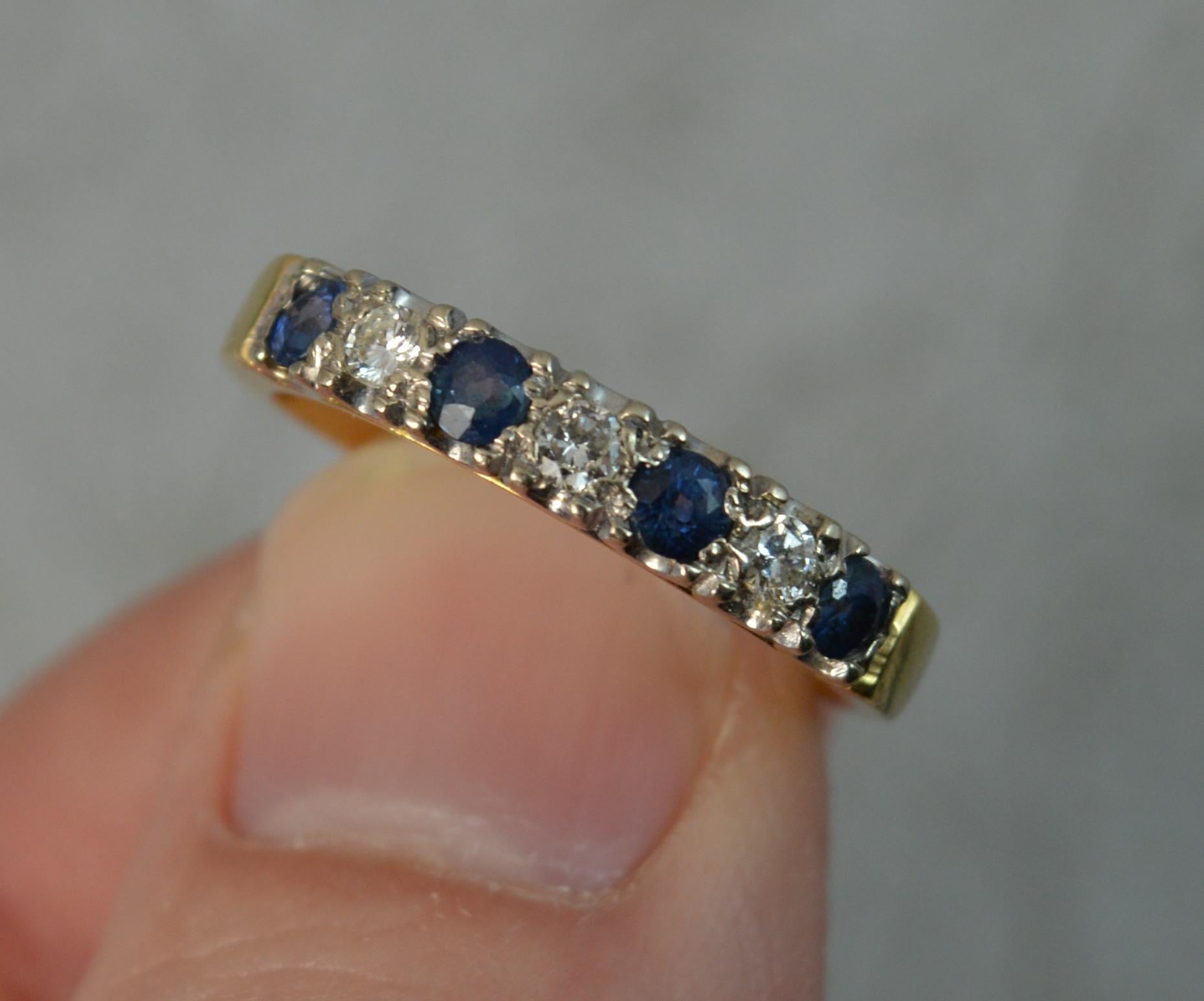A beautiful Sapphire and Diamond ring.
Solid 18 carat yellow gold example.
Designed with alternating round brilliant cut blue sapphires and diamonds in grain settings. Suitable for wearing alongside other rings.
18mm spread of stones. 3.5mm wide