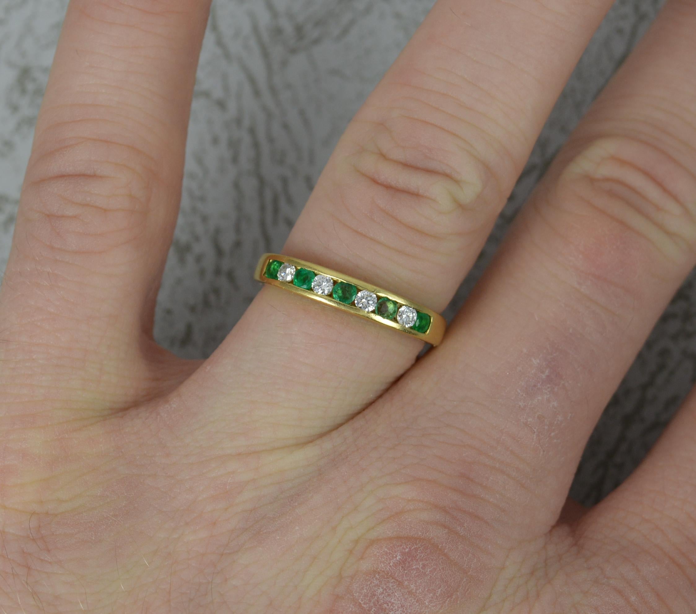 A beautiful half eternity, stack ring.
Solid 18 carat yellow gold example.
Designed with alternating natural round cut emerald and diamonds. Channel set. Very clean and sparkly diamonds, vs grade. Vibrant green emeralds. All natural.
17mm spread of