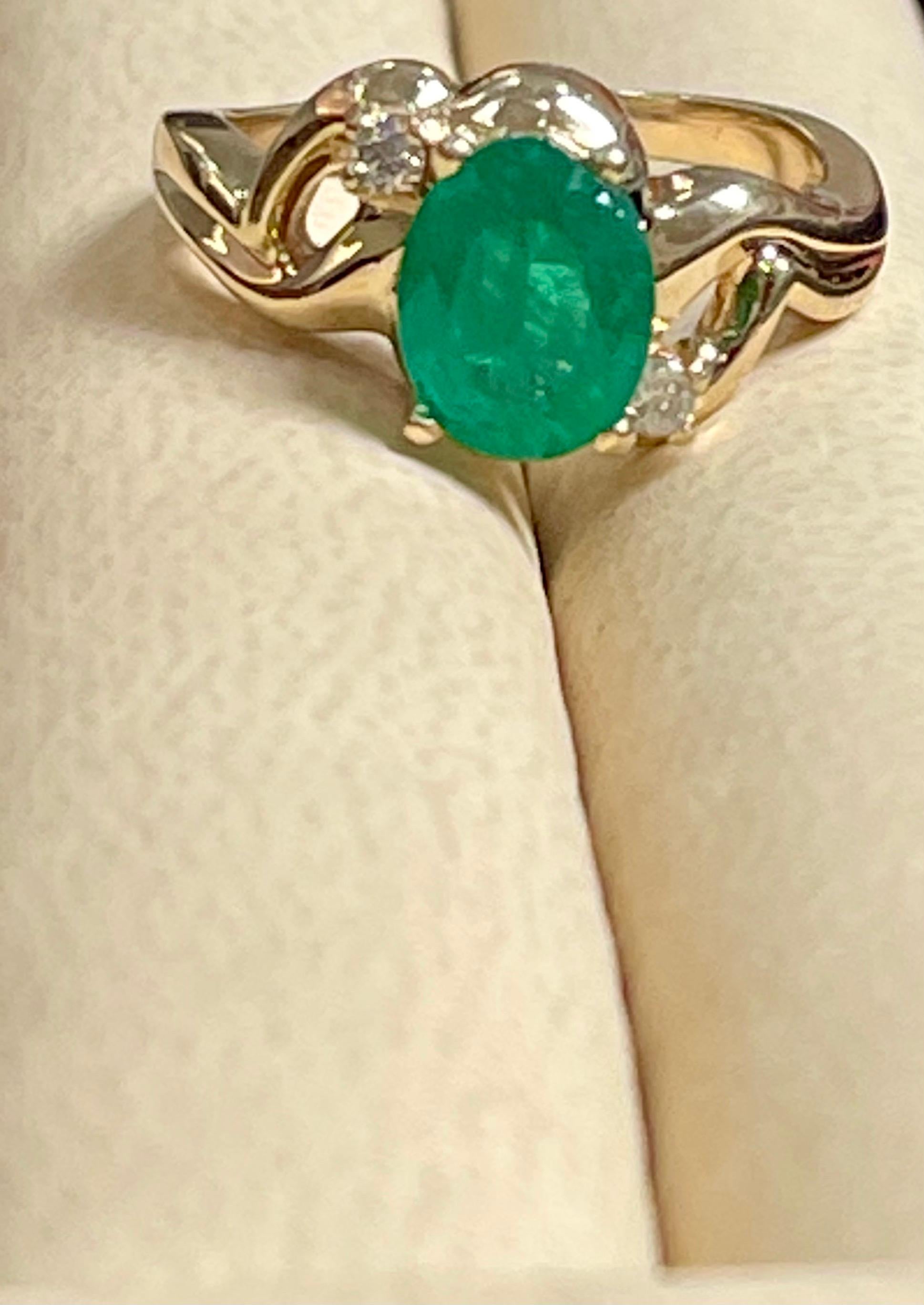 oval emerald ring with diamonds in yellow gold