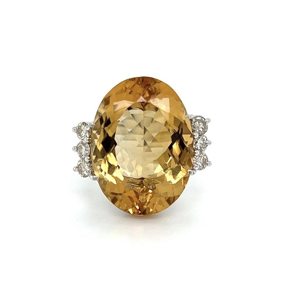 Simply Beautiful! Elegant and finely detailed Oval Citrine and Diamond Vintage Gold Cocktail Ring. Centering a securely nestled Hand set 18 Carat Oval Citrine. Accented either side with Diamonds, weighing approx. 0.56tcw. The ring is Hand crafted in