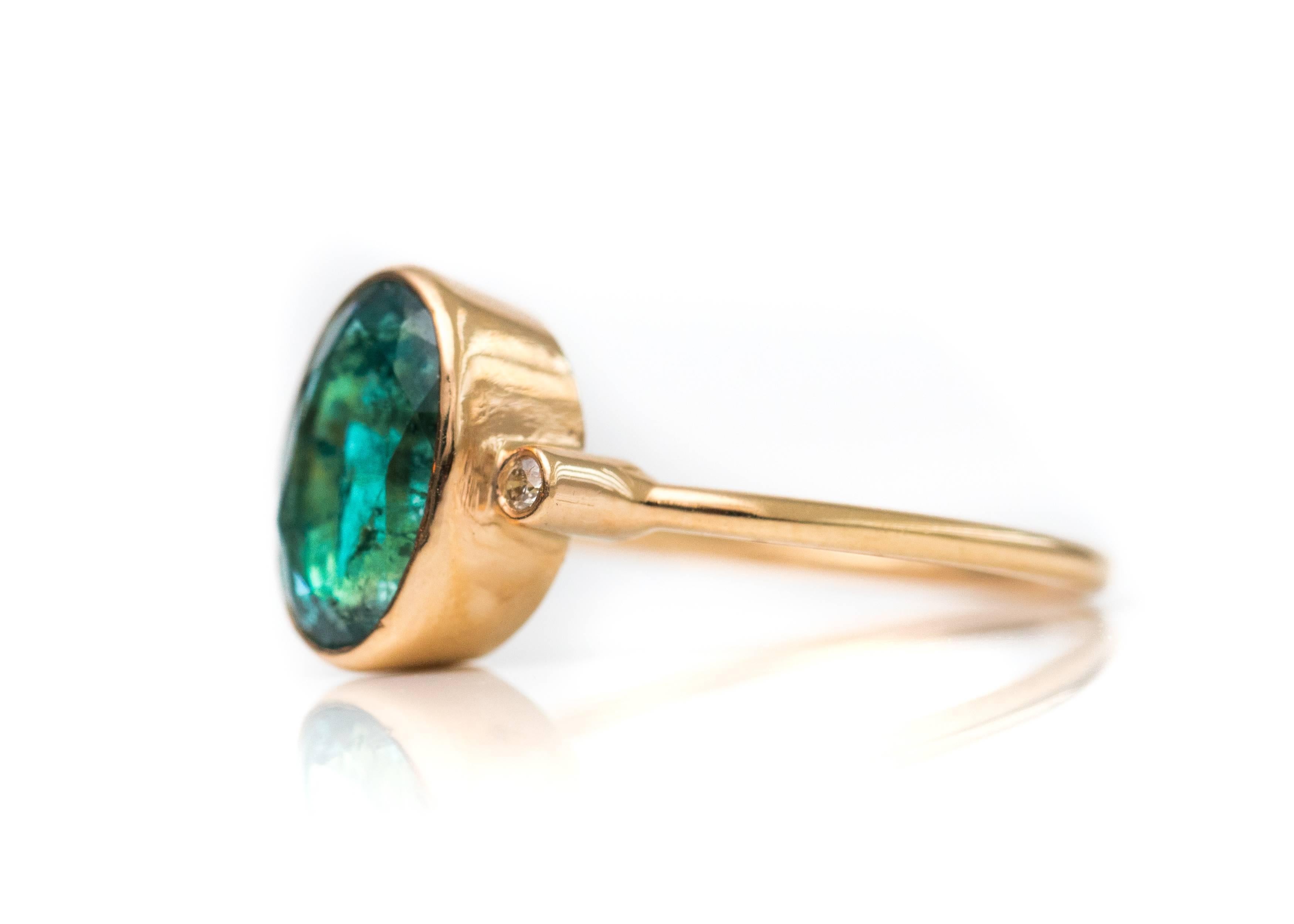 1.8 Carat South American Emerald with Diamonds and 18 Karat Yellow Gold Ring

Features a 1.8 carat deep blue South American Emerald center stone, Round Brilliant Diamonds and 18 Karat Yellow Gold. The stunning Oval Emerald center stone is bezel set