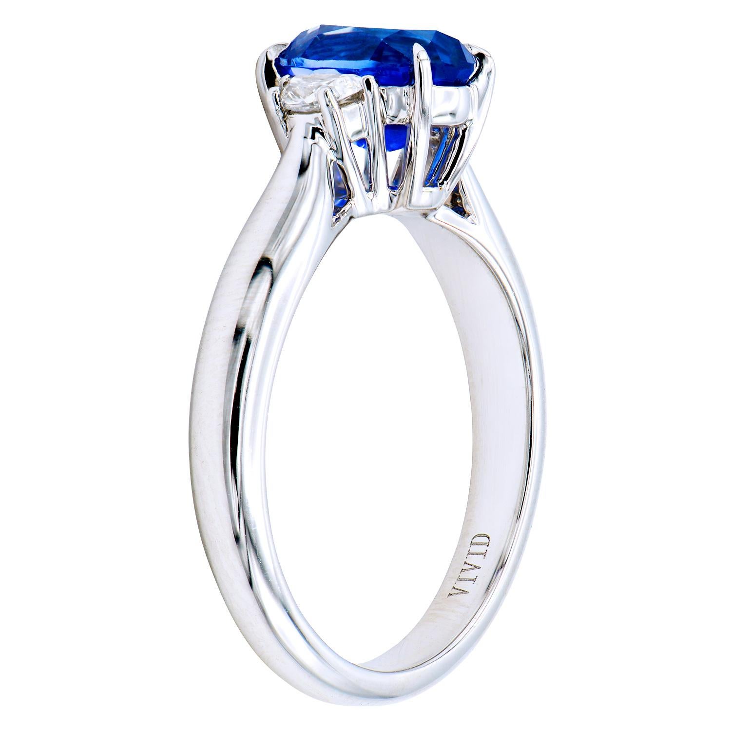 This beautiful 1.80 carat oval Ceylon Blue Sapphire is beautifully set in an 18 karat white gold ring made from 4.6 grams of white gold with 2 Half Moon cut side stones totaling 0.16 carats. This ring is size 6.5.   