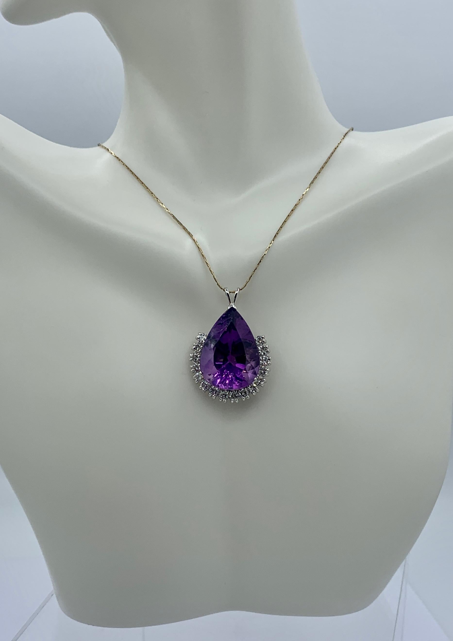 THIS IS A MAGNIFICENT JEWEL.  THE STUNNING MONUMENTAL 18 CARAT PEAR SHAPED FACETED SIBERIAN AMETHYST OF GREAT BEAUTY IS SURROUNDED BY 16 DIAMONDS TOTALING APPROXIMATELY 1.5 CT IN A CLASSIC 10K WHITE GOLD SETTING.
The breathtaking jewel features a