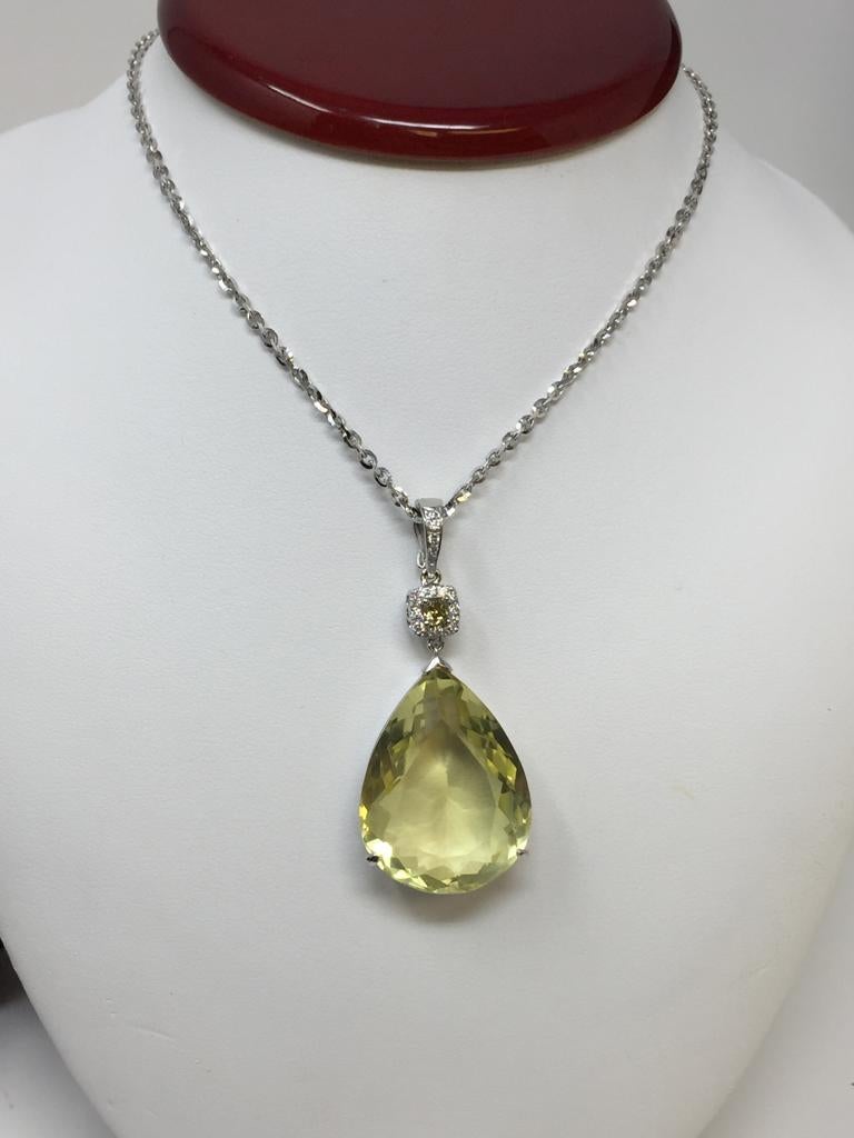 Beautiful 18kt white gold yellow pear shape citrine and diamond pendant, the yellow citirne weighs approx. 18 carats and measures approx  28 mm x 22mm. 
The fancy yellow diamond in the center weighs approx 0.35ct of SI1 quality and in fancy yellow