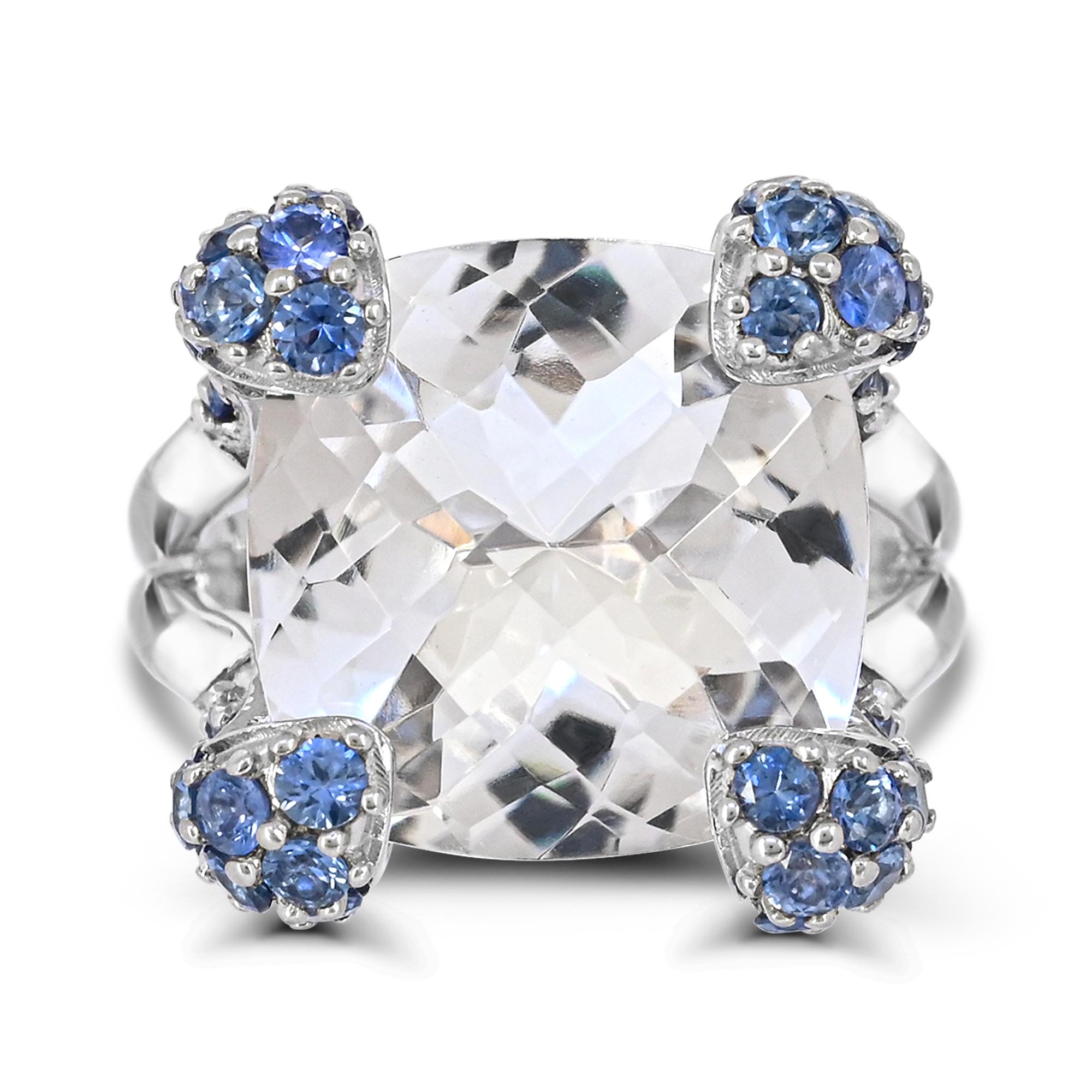 Indulge in the uniqueness of our Cushion-Cut Rock Crystal and Blue Sapphire Accented Sterling Silver Cocktail Ring. Crafted with meticulous attention to detail, this ring boasts a spectacular combination of one 14-3/8 carat cushion-cut rock crystal