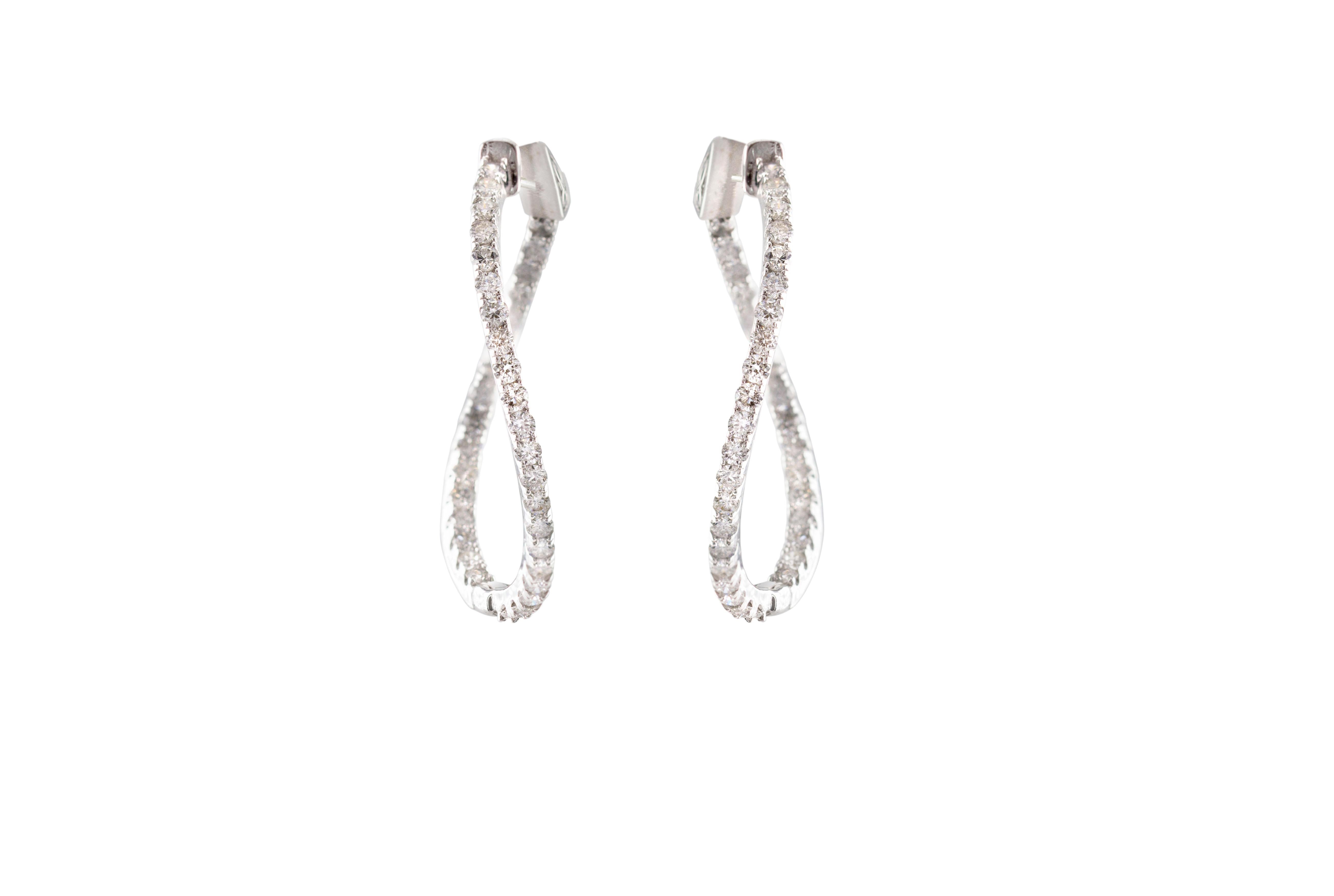 Embrace the allure of these exquisite hoop earrings that offer a delightful twist on the classic style, featuring 1.8 carats natural round diamonds. At first glance, you'll recognize the timeless beauty of hoop earrings, but upon closer inspection,