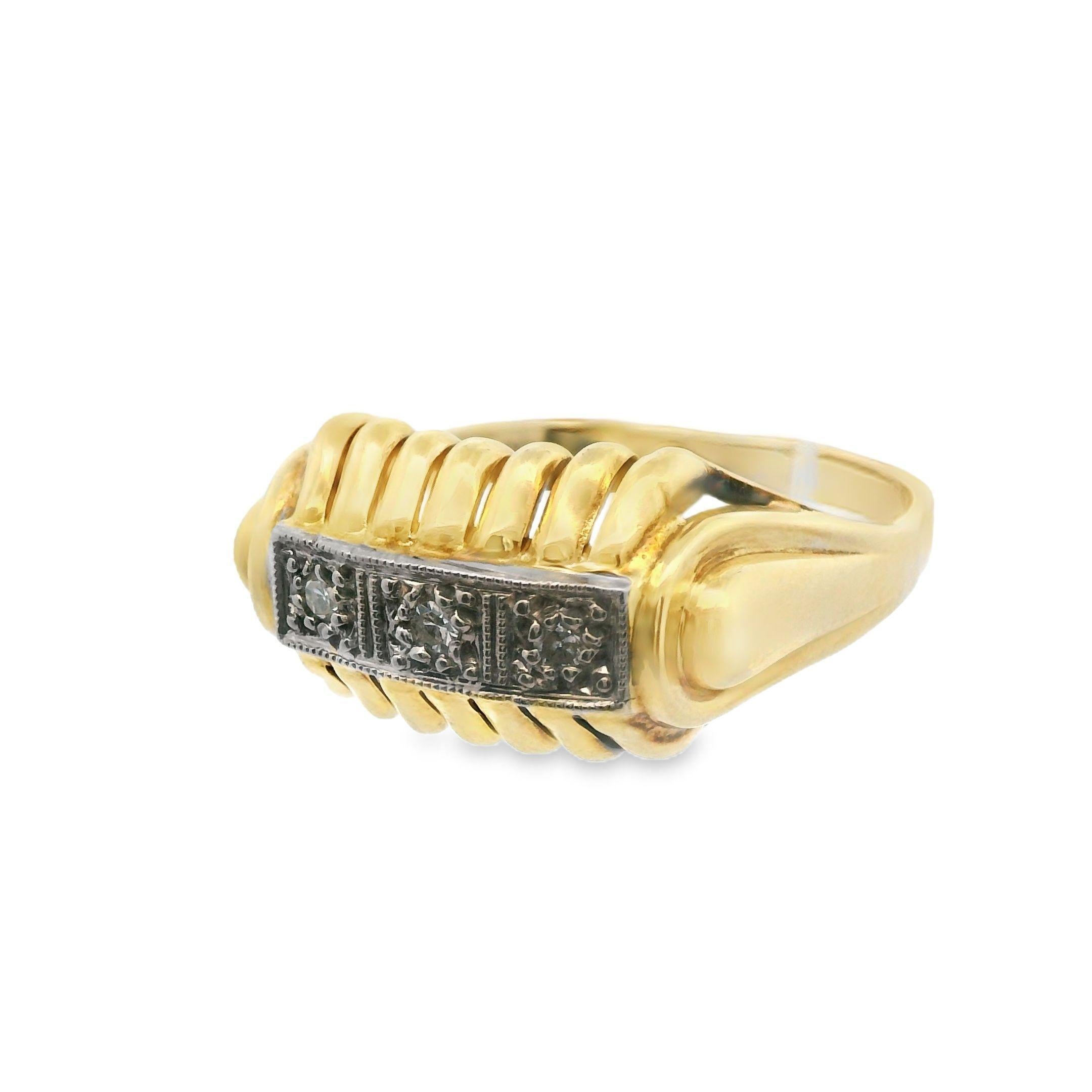 This beautiful mid-century three stone diamond ring is made in 14k yellow gold. This ring is dynamic and symbolic; it takes a classic three stone layout, which symbolizes the past, present and future. The shoulders of the ring are incorporated into