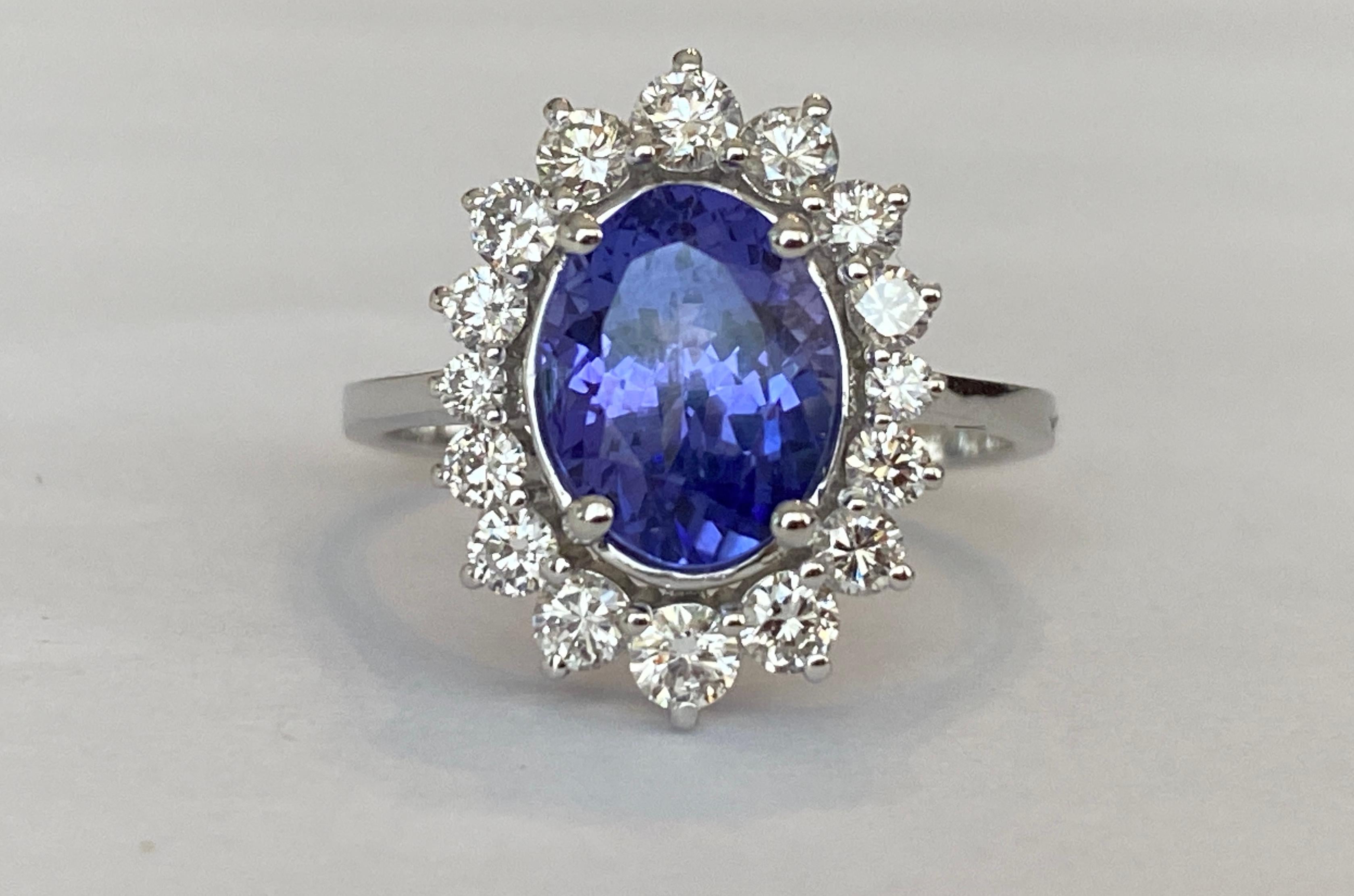 Offered in new  condition, Diana Cocktail ring in white gold, with an oval cut tanzanite of 2.50 ct. The stone is surrounded by an entourage of 16  pieces of brilliant cut diamonds, approx. 0.75 ct in total, of quality F/G/VS/SI. Own certificate is