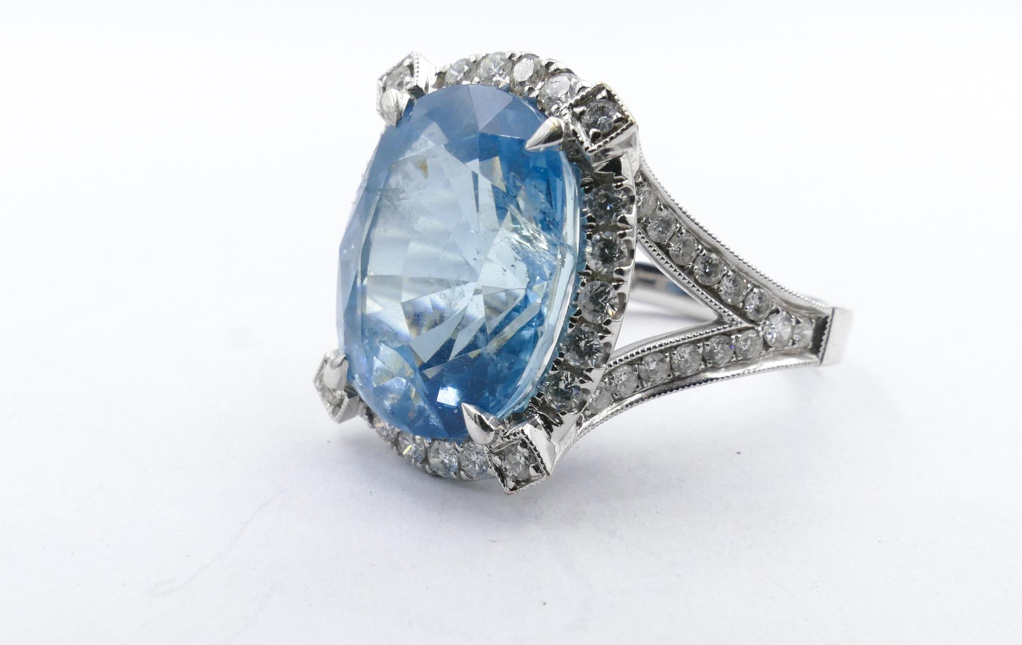 A large Oval Cur 11.75 Carat Aquamarine Stone (15.47mm X 12.57mm X 9.62mm) of a beautiful mid blue with very minor inclusions is the centrepiece of the Ring. Surrounding it are 122 Brilliant Cut Diamonds, grain micro-claw set, Colour G/H and clarity