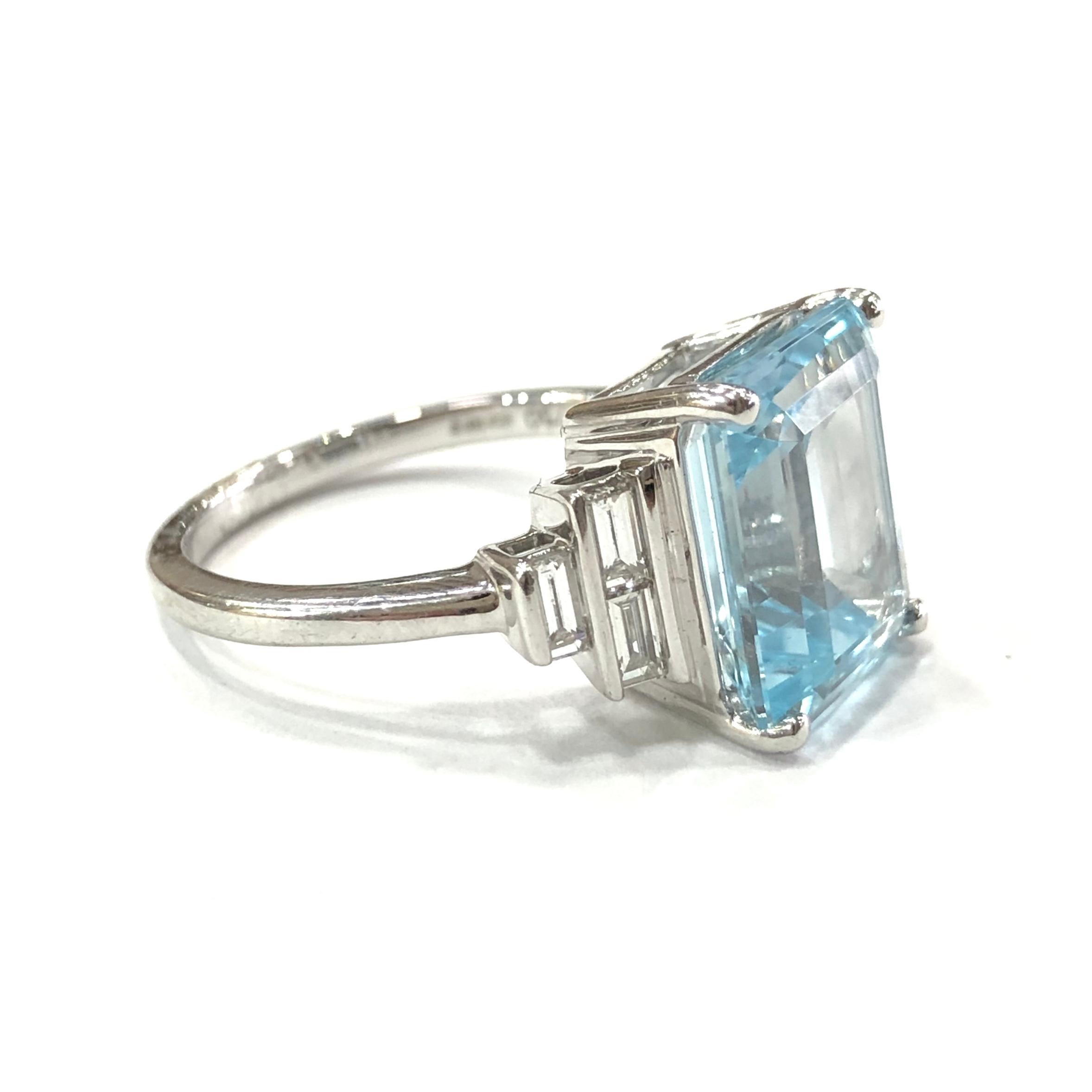 18ct White Gold Aquamarine and Diamond Ring. Set with a large 12x10mm central emerald cut Aquamarine set in a four claw setting. With six Baguette shape Diamonds set on the shoulders in a rubover setting. (three on each side)
With a full english