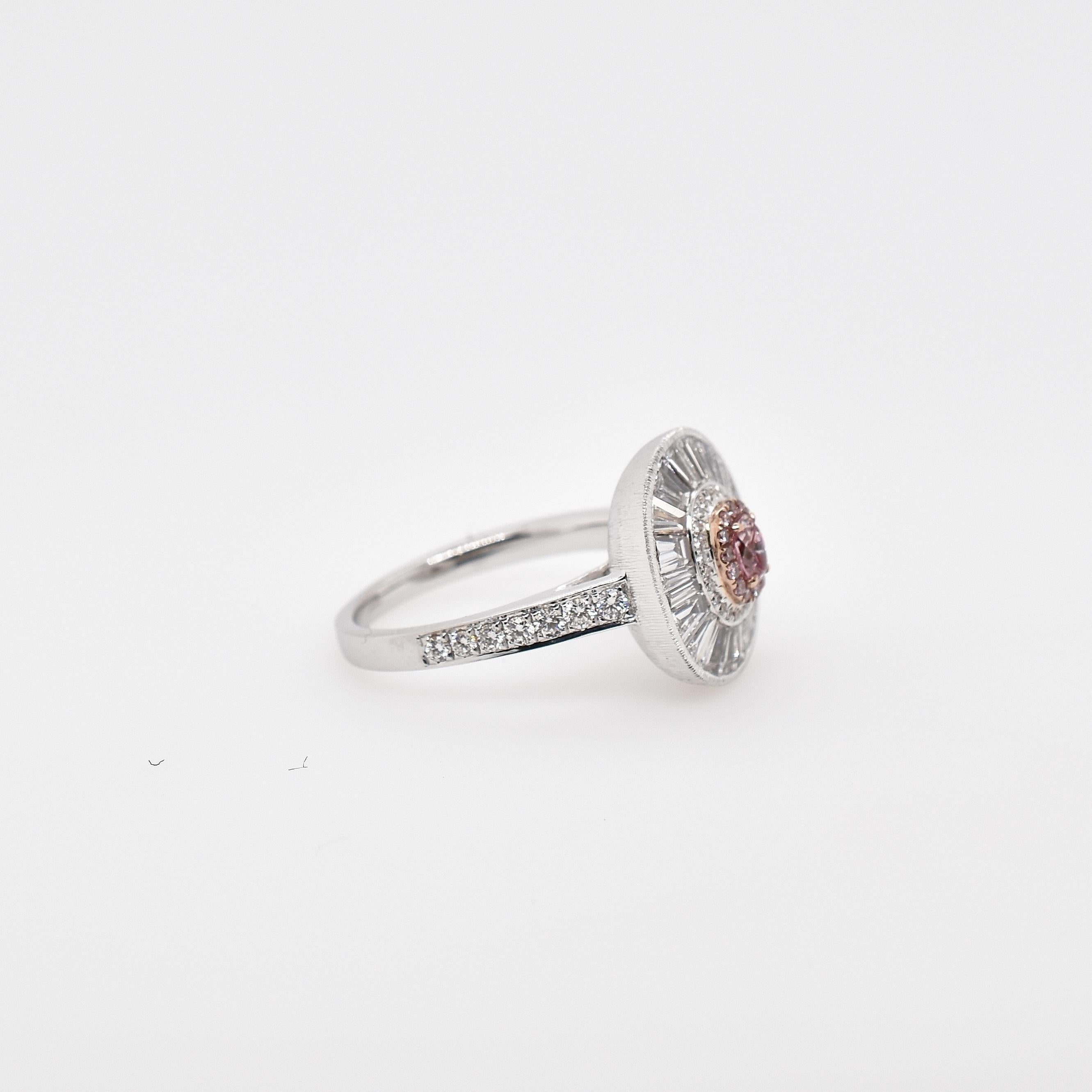 18ct white and rose gold diamond cluster ring with pink oval centre, tapered baguette cluster and grain set shoulders with closed satin finish under mount and grain set diamond shoulders. The centre oval pink diamond is 0.15ct surrounded by 14 round