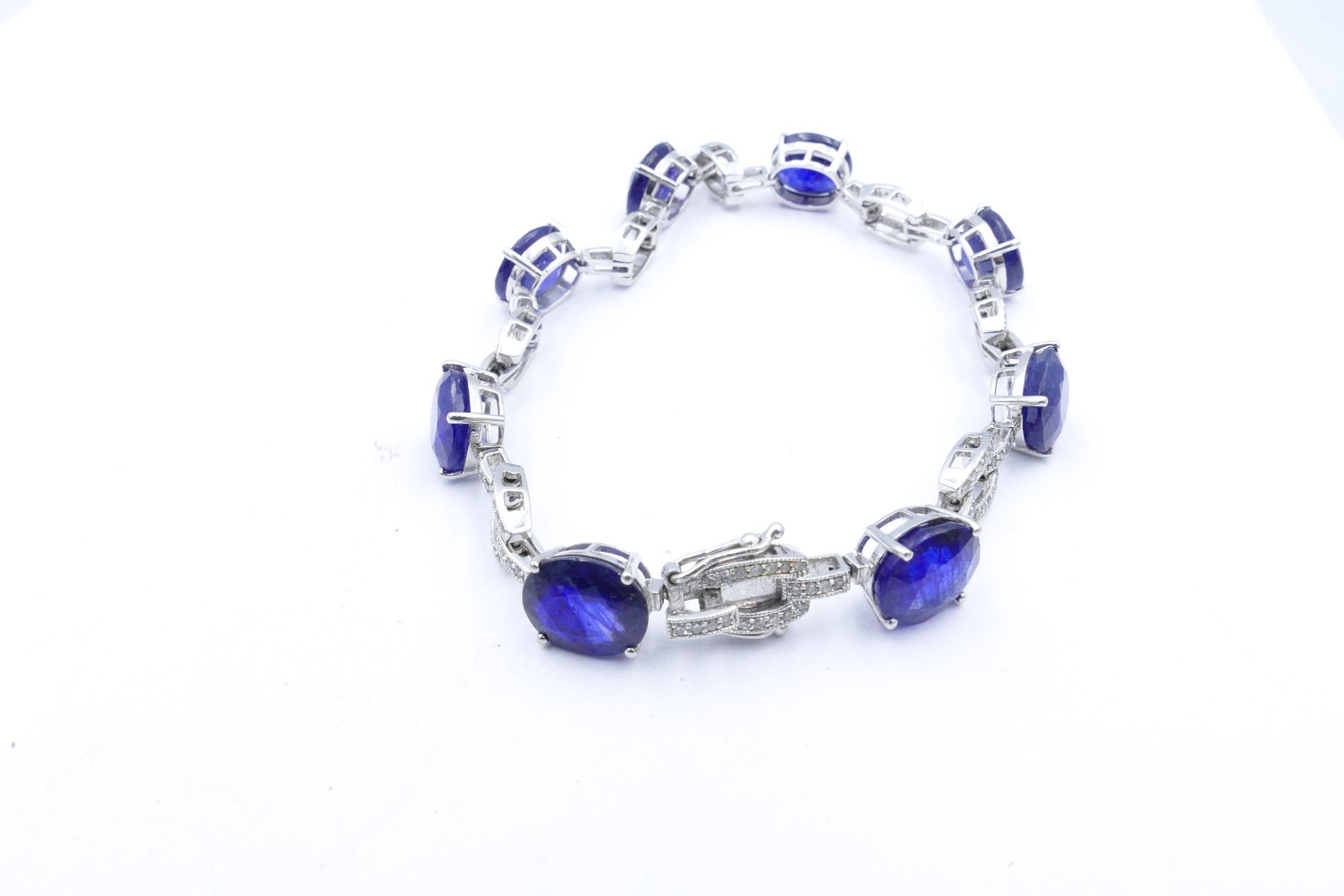 This very pretty Bracelet has 18 Ceylon type oval cut, royal blue Sapphires with excellent clarity, individually claw set, flanked by 17 round single cut Diamonds, micro claw set, colour H/I and clarity SI1 - SI2'
Measurement is 17.9cm X 3.89mm with