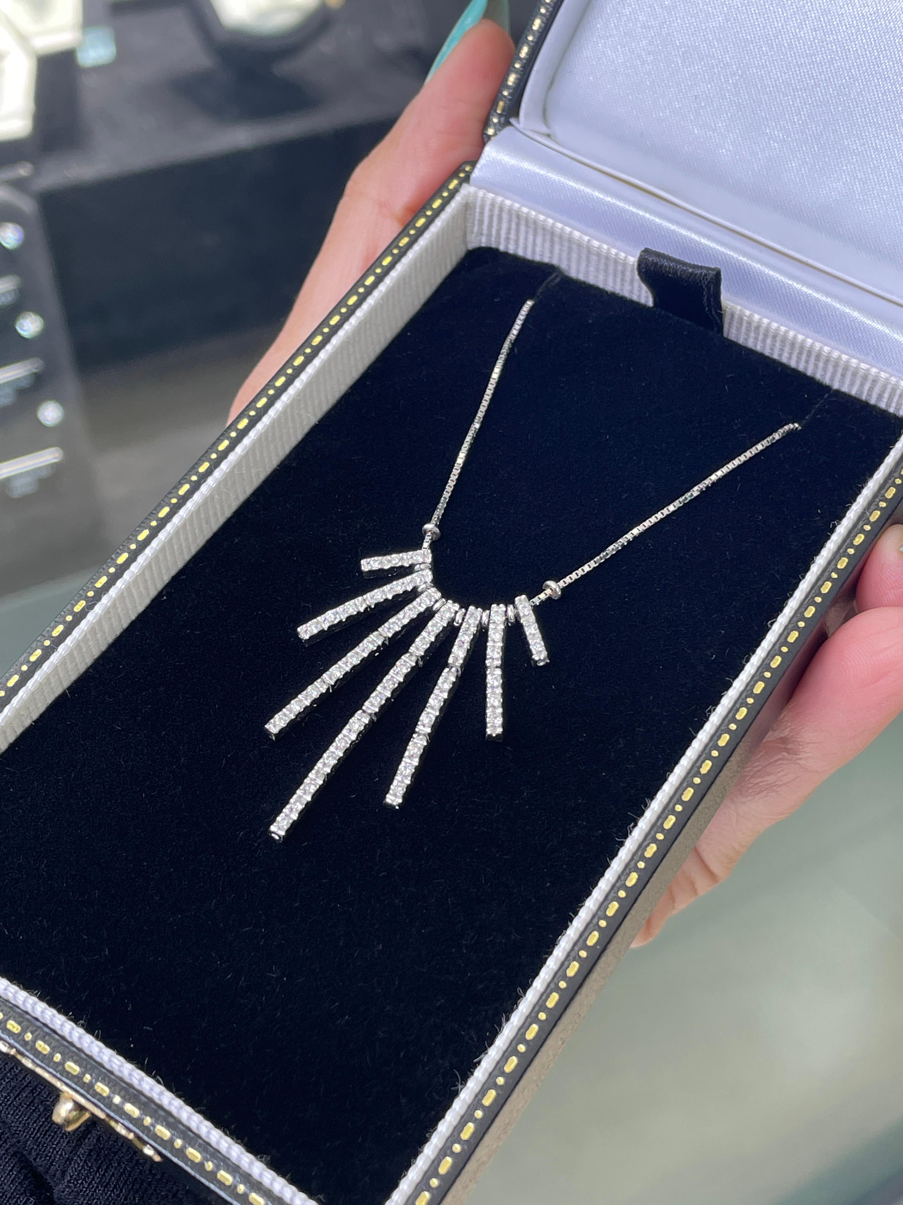 Crafted in 18 carat white gold, this elegant diamond cascade necklace showcases a delicate arrangement of sparkling diamonds that gracefully descend from the neckline, designed to mimic the flow of a waterfall. The centrepiece is formed of seven