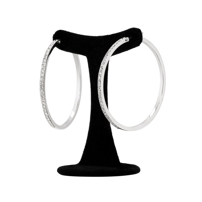 These beautiful hoop earrings are perfectly inlaid with 26 fine quality round brilliant cut diamonds in each hoop totalling to an approximate weight of 0.80 carat mounted in 18 carat white gold. The earrings weigh 14.88 grams, measure 4.5cm in