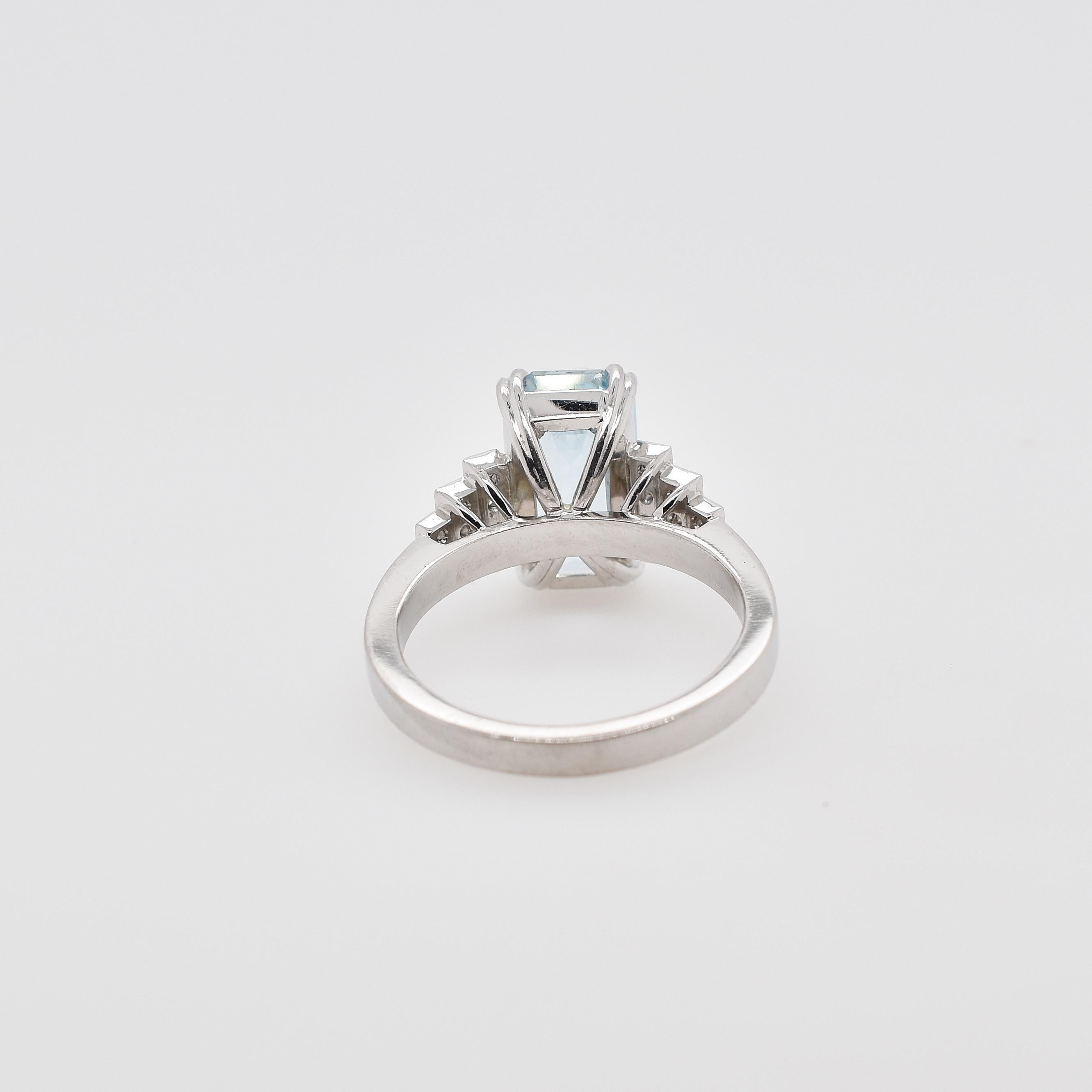18ct white gold emerald cut aquamarine and brilliant cut diamond ring. The aquamarine is 3.26ct and is set in 4 double claws while the 18 diamonds are grain set as stepped shoulders. 18 round brilliant diamonds totalling 0.17ct D-F VS-SI
ring size -