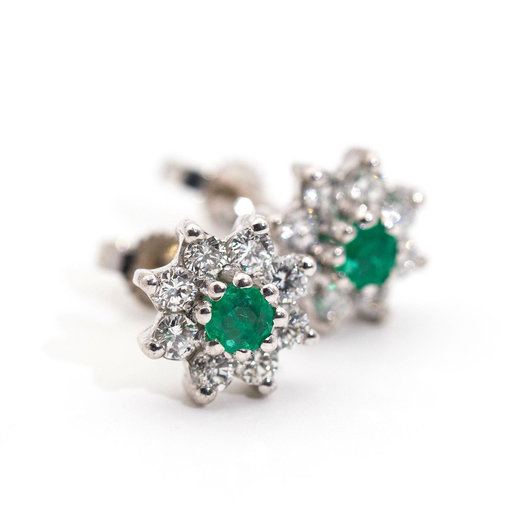 These timeless cluster stud earrings are forged in 18ct white gold and each earring features a beautiful bright round green emerald each encompassed by sparkling round brilliant cut diamonds. We have named this pair of gorgeous vintage splendour The