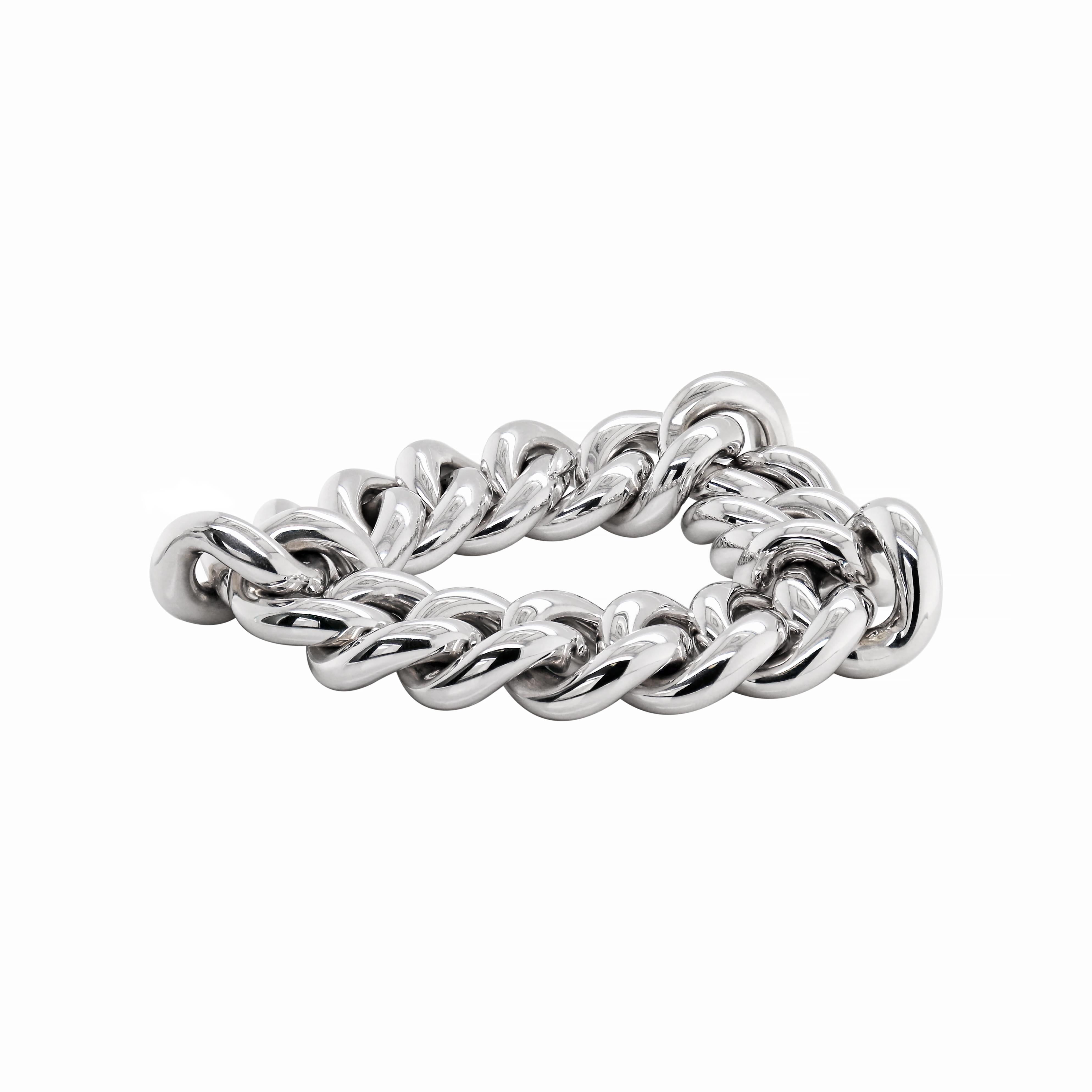 This beautiful chunky bracelet is crafted in 18 carat white gold and features high-polished large hollow curb links. This piece is wonderfully finished with a hidden link clasp which is embellished with a rubover set round brilliant cut diamond. The