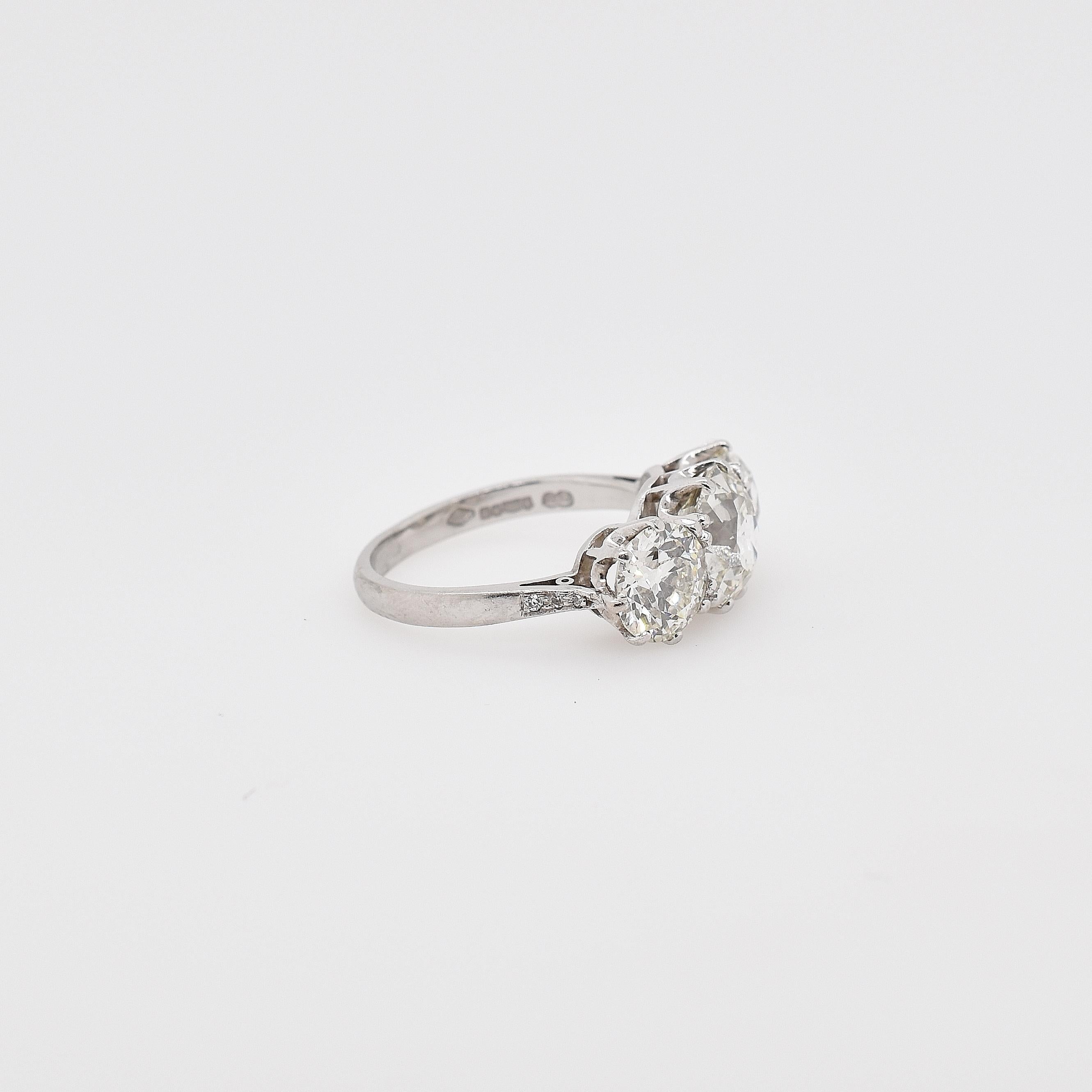 18ct white gold old cut diamond three stone ring. The three large diamonds are in 8 claw settings. The centre old cut diamond is 2.52ct, J SI1. The two side old cut diamonds measure 1.40ct J VS2 and 1.35ct J VS2. 
US size 7 - can be resized
