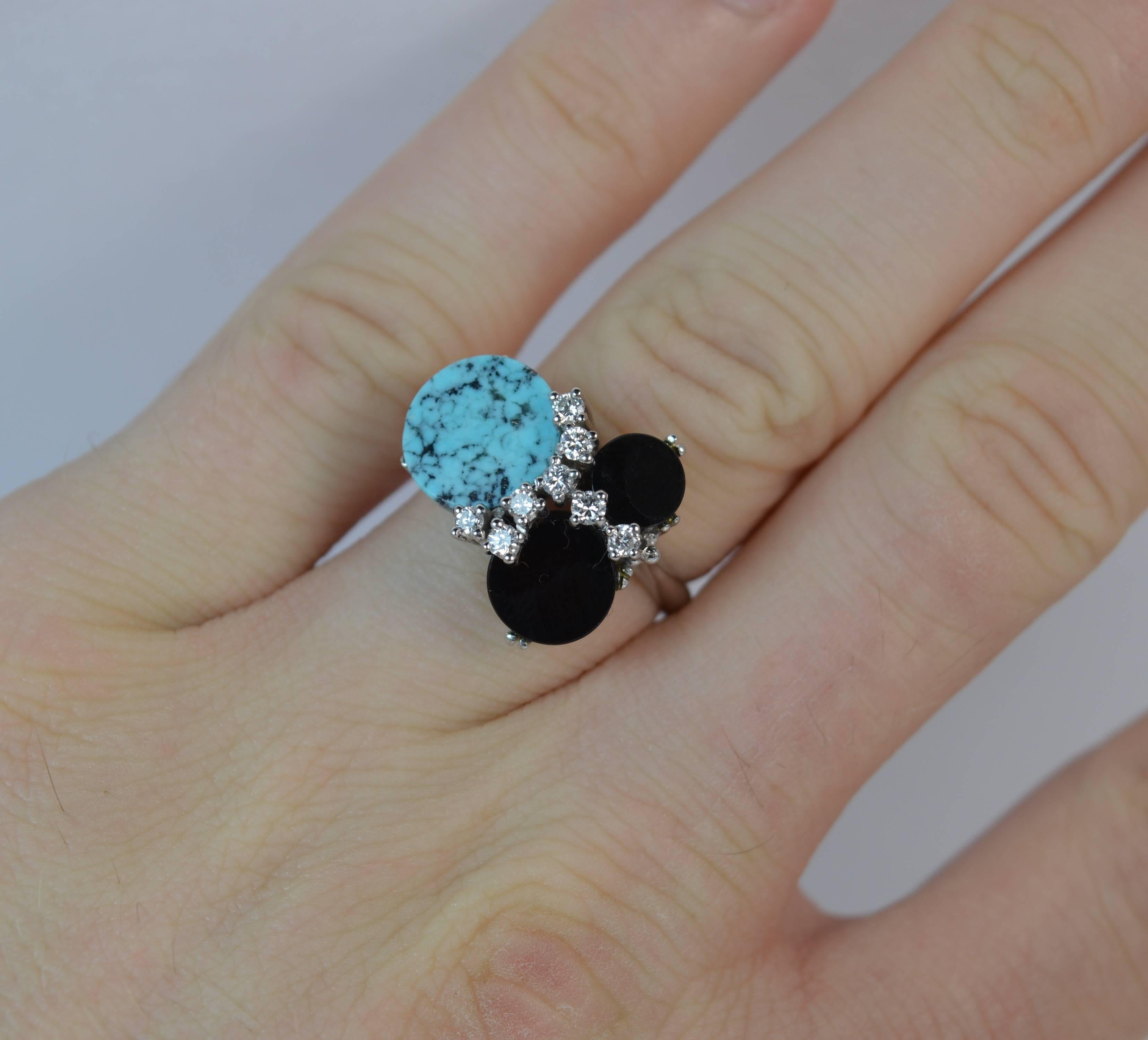 
A very stylish vintage cluster ring.

Solid 18 carat white gold shank and setting.

​Designed with a round turquoise and two smaller round onyx stones with round brilliant cut diamonds set in between.

​18mm x 15mm head, protruding 9mm off the