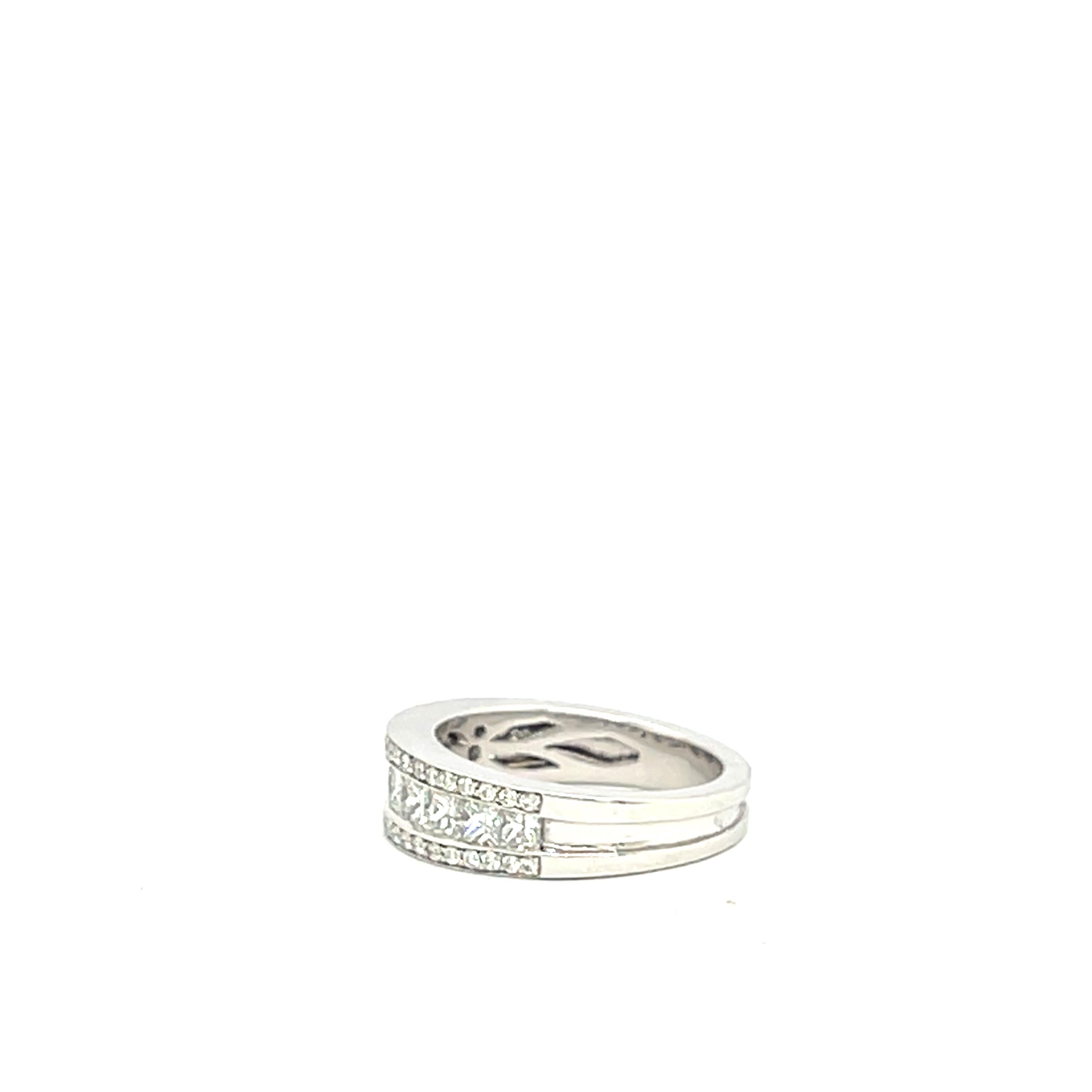 18 Carat White Gold Ring Set with Princess and Brilliant Cut Diamonds

Total weight: 6.99 grams

Modern and elegant ring in 18k white gold, set with a row of princess-cut diamonds in a channel setting, framed by two rows of finely paved