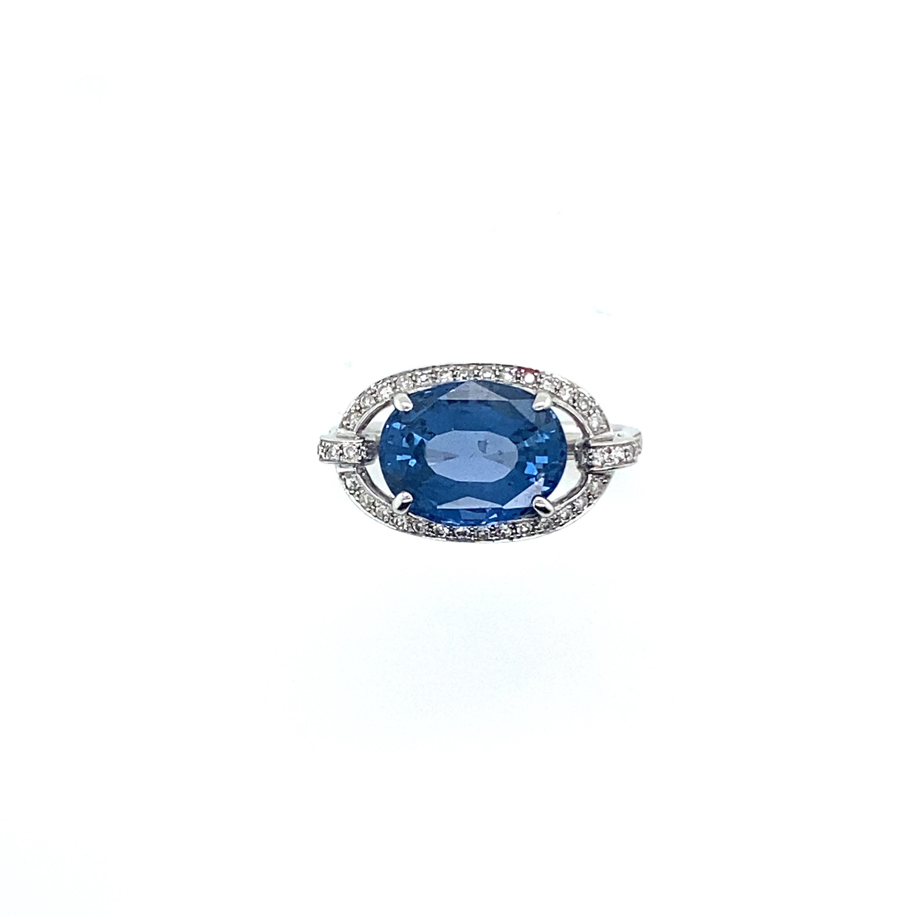 Women's 18 Carat White Gold Ring Topped with a Blue Spinel Surrounded by Diamonds For Sale