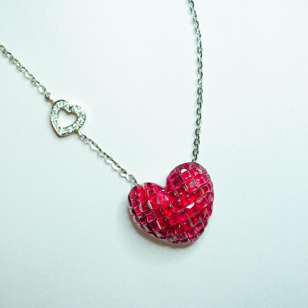  We design a very nice Heart pendant .The technique use invisible setting .We cut and groove very stone. This pendant is very nice style you can use in many occasion in day time and evening time for party. Ruby use 10.60 ct,  Diamond 0.14 ct F VS