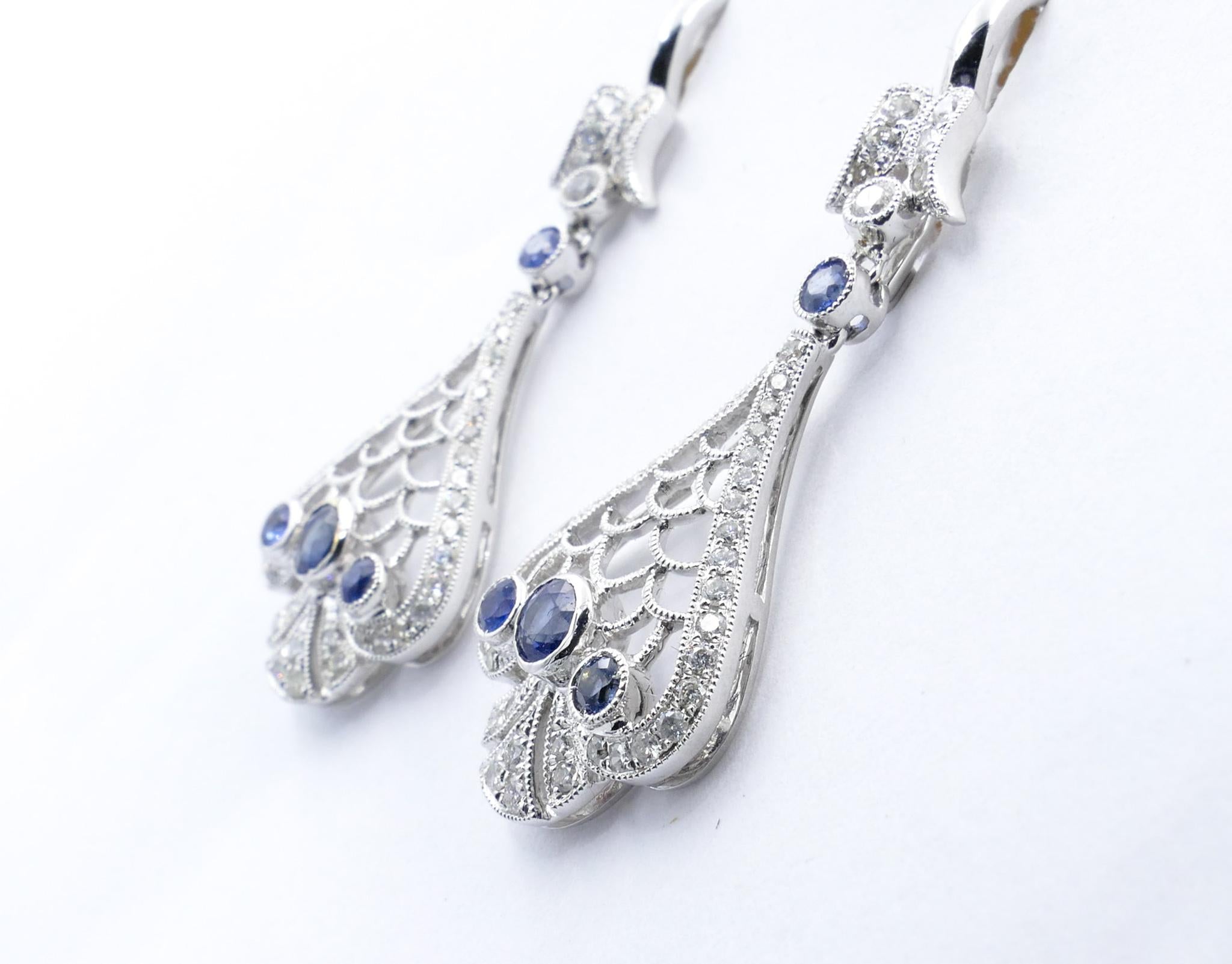 8 medium blue Ceylon Sapphires, clarity eye clean, bezel set with Milligrain detail, and 98 Round Brilliant Cut Diamonds Colour G/H, Clarity SI1 - SI2 make up these very pretty Earrings.
The Earrings measure 43mm X 15mm and feature Lever Back