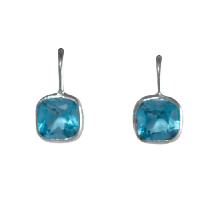 18 Carat White Gold Swiss Blue Topaz Earrings.

Esther Eyre has been designing and making precious jewellery for over twenty years. She trained at Kingston and Middlesex gaining a BA in jewellery design in 1982. Esther worked briefly in Mappin &