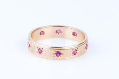 18 carat yellow gold alliance designed with 10 round rubies weighing 0.20 carat