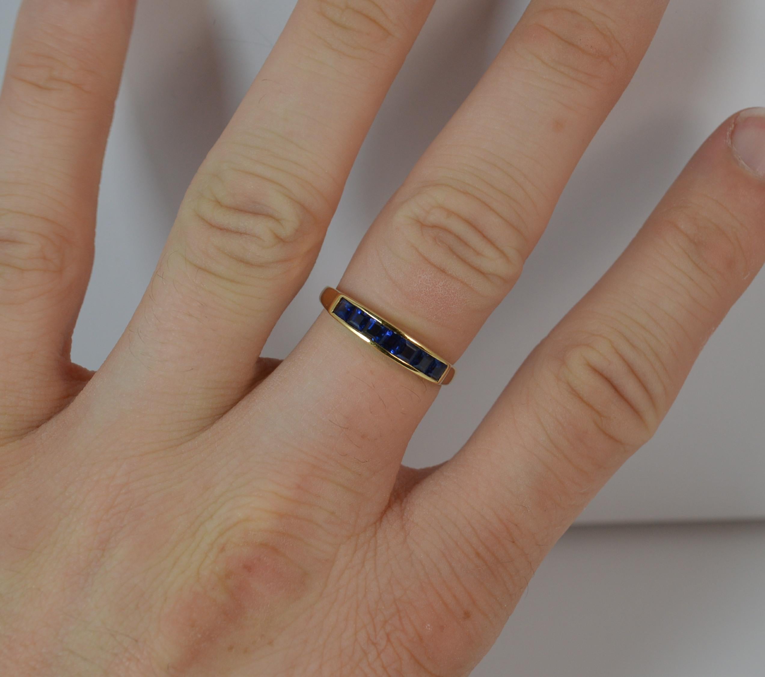 A superb contemporary half eternity stack ring.
Size ; P 1/2 UK, 7 3/4 US
Solid 18 carat yellow gold example.
Designed with seven princess cut sapphires in tension channel setting.
15mm spread of stones. 3.7mm wide band to front.

Condition ; Very