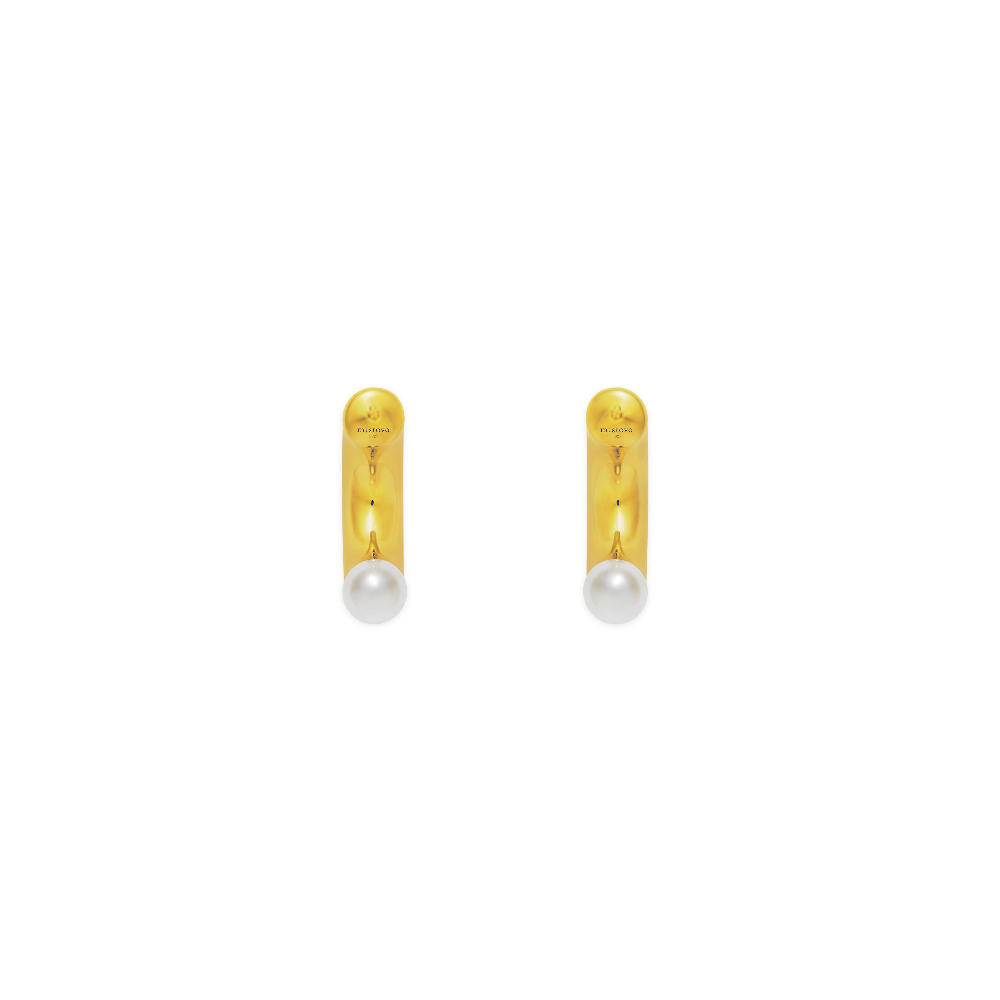 Strong and modern looking Mistova's Anneal earrings are a new take on pearls. A modernist piece of jewelry. Made from a curved hollow tube these earrings are easy to wear. Made from the finest 18K gold and real pearls.