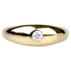 18 carat yellow gold band ring designed a round brilliant cut diamond