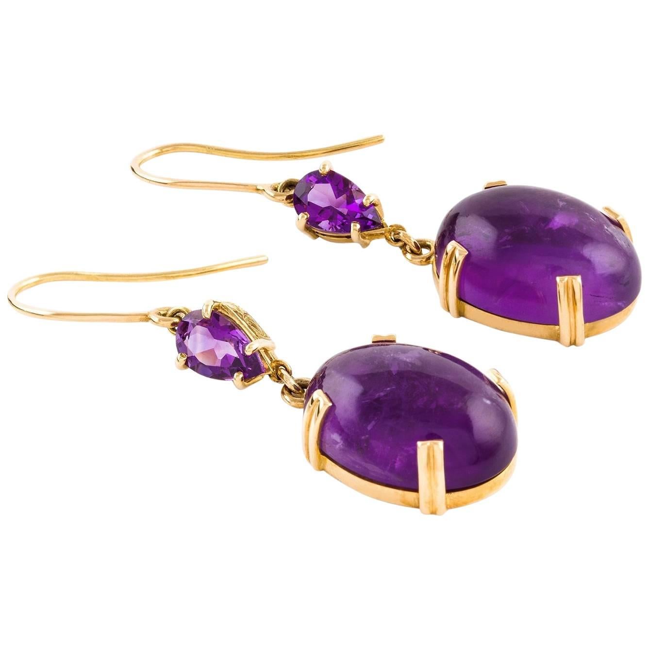 Oro Violet Earrings

These stunning handmade earrings in 18ct yellow gold feature a pair of large cabochon cut amethysts together with a smaller pair of pear faceted amethysts.

Cabochon cut amethysts: medium purple colour, 17.84 x 13.0 x 7.7mm