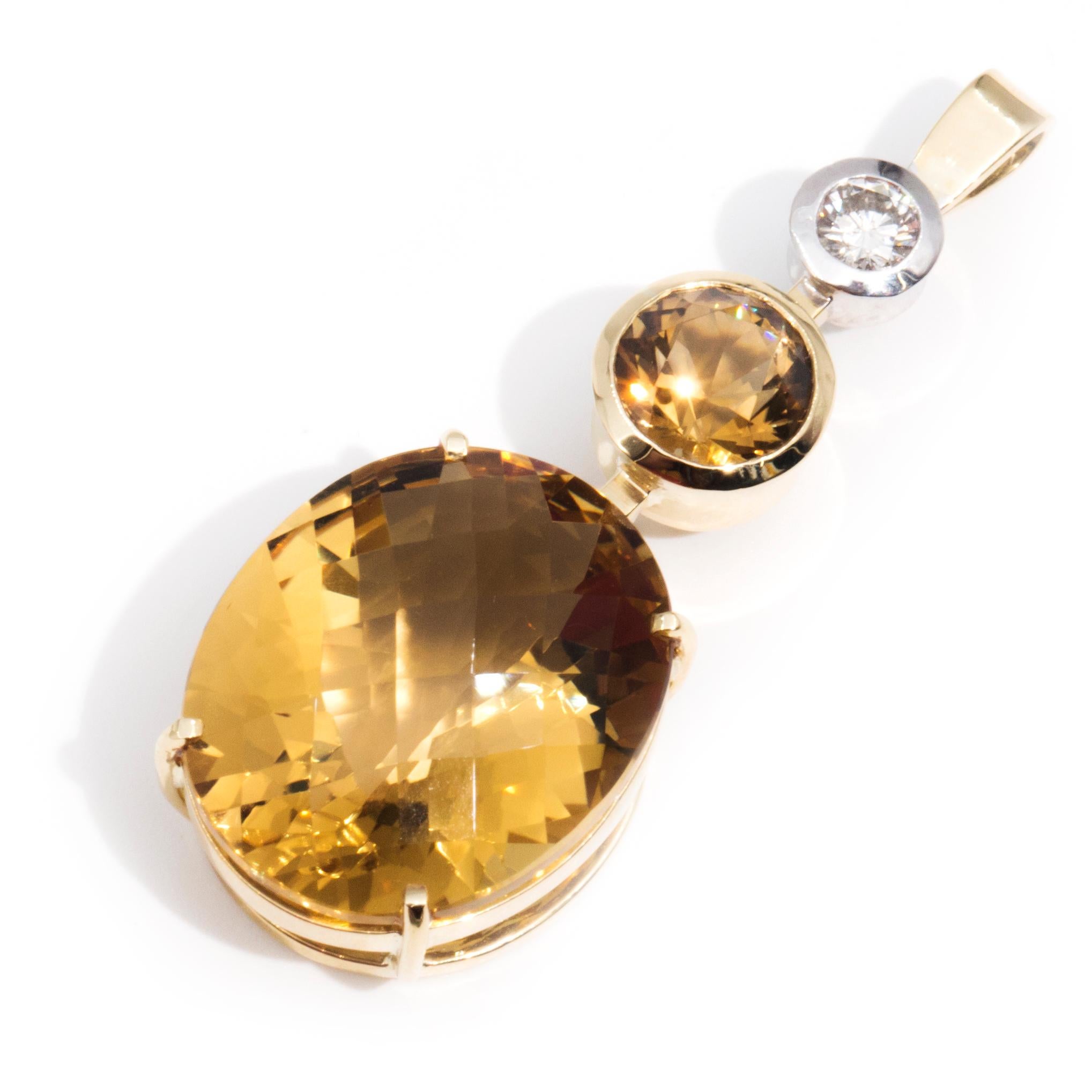 Forged in 18 carat yellow gold, this charming vintage pendant features a boastful three-tiered drop set with one 0.30 carat rub over round brilliant diamond at the apex. Below is one round deep yellow citrine and below that is the stunning