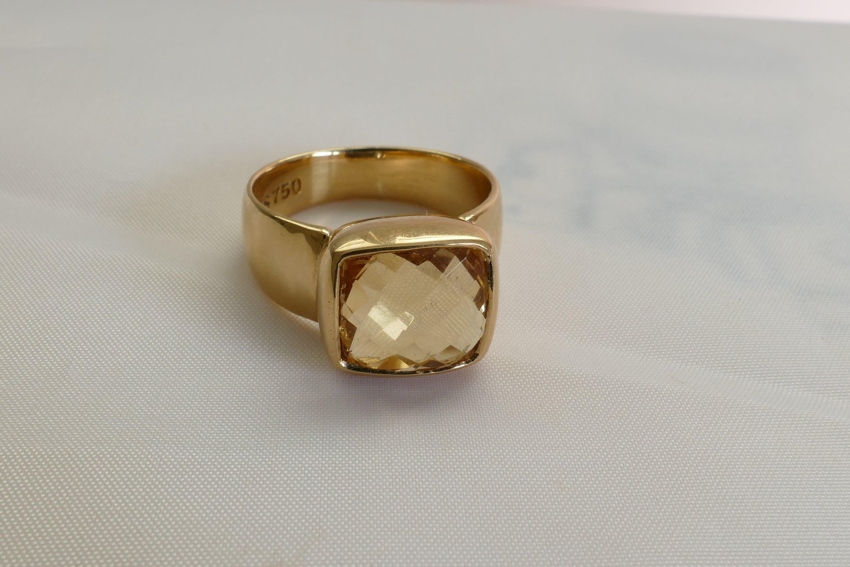 The Citrine Ring is Chequerboard Bezel set and has been manufactured by Dracakis.
The Stone is eye clean and a clear yellow in Colour.
The Band is polished, half round slightly reverse tapered and measures 5.14mm wide at the base of the Shank,