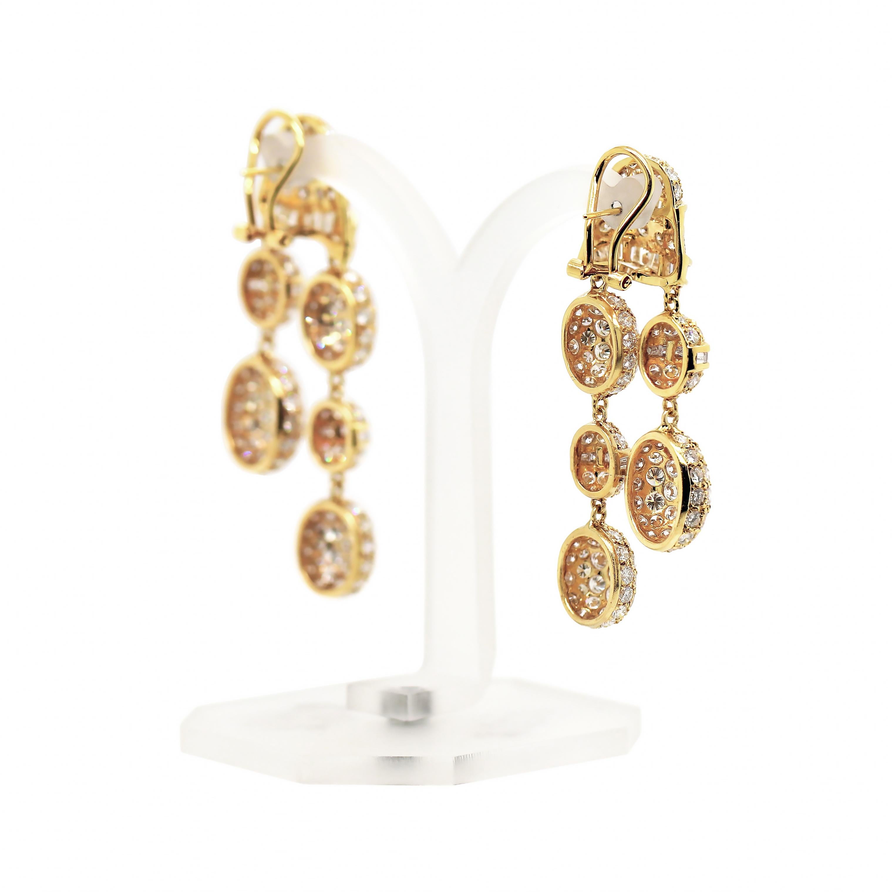 These one of a kind glamorous drop earrings are uniquely designed with beautiful movement. Each earring is pavé set with 153 fine quality round brilliant cut diamonds and 36 channel set baguette cut diamonds weighing an approximate total weight of