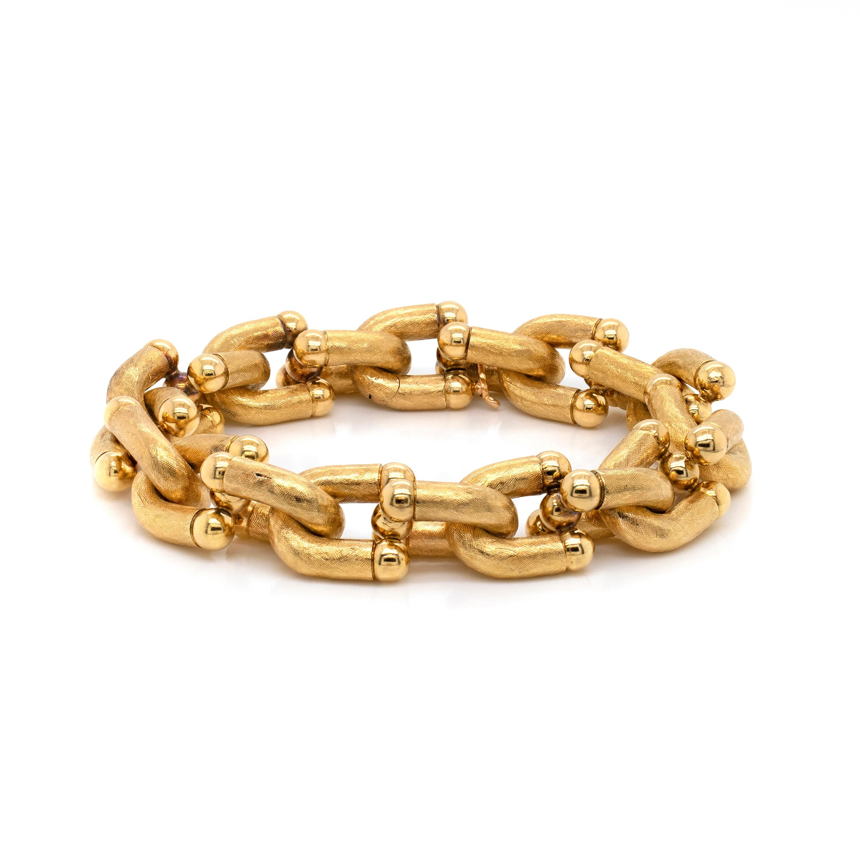 This gorgeous Georges L'Enfant vintage hardware textured link bracelet has been crafted in 18 carat yellow gold. The piece consists of 20 'U' shaped links all hand finished with an etched texture giving the bracelet a wonderful sheen.  The bracelet