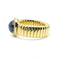 18 Carat Yellow Gold Flexring with a 3.06 Carat Sapphire and Diamonds Around