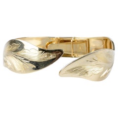 18 carat yellow gold opening and rigid leaves bracelet 