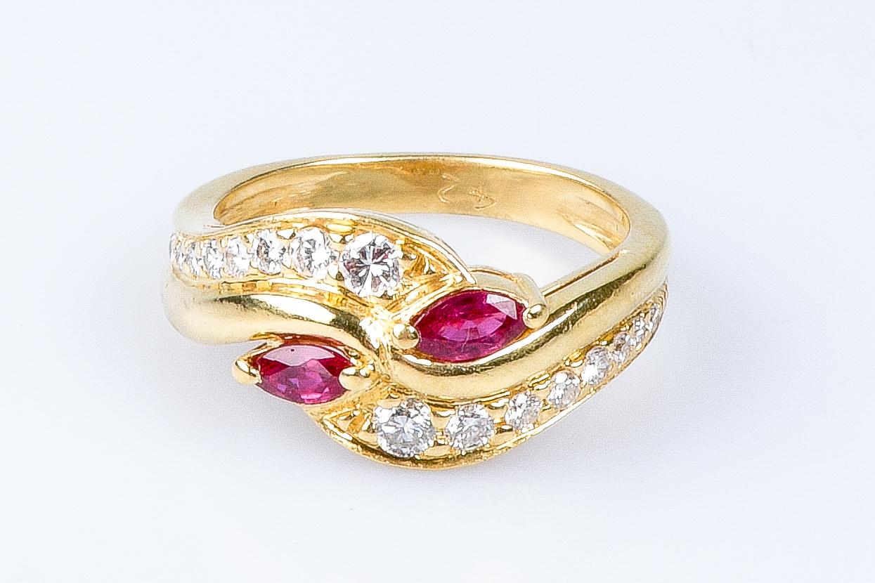 18 carat yellow gold ring designed with 2 marquise cut rubies weighing 0.16 carats, 2 round brillant cut diamonds weighing 0.12 carats, 2 round brillant cut diamonds weighing 0.08 carats, 4 round brillant cut diamonds weighing 0.12 carats, 4 round