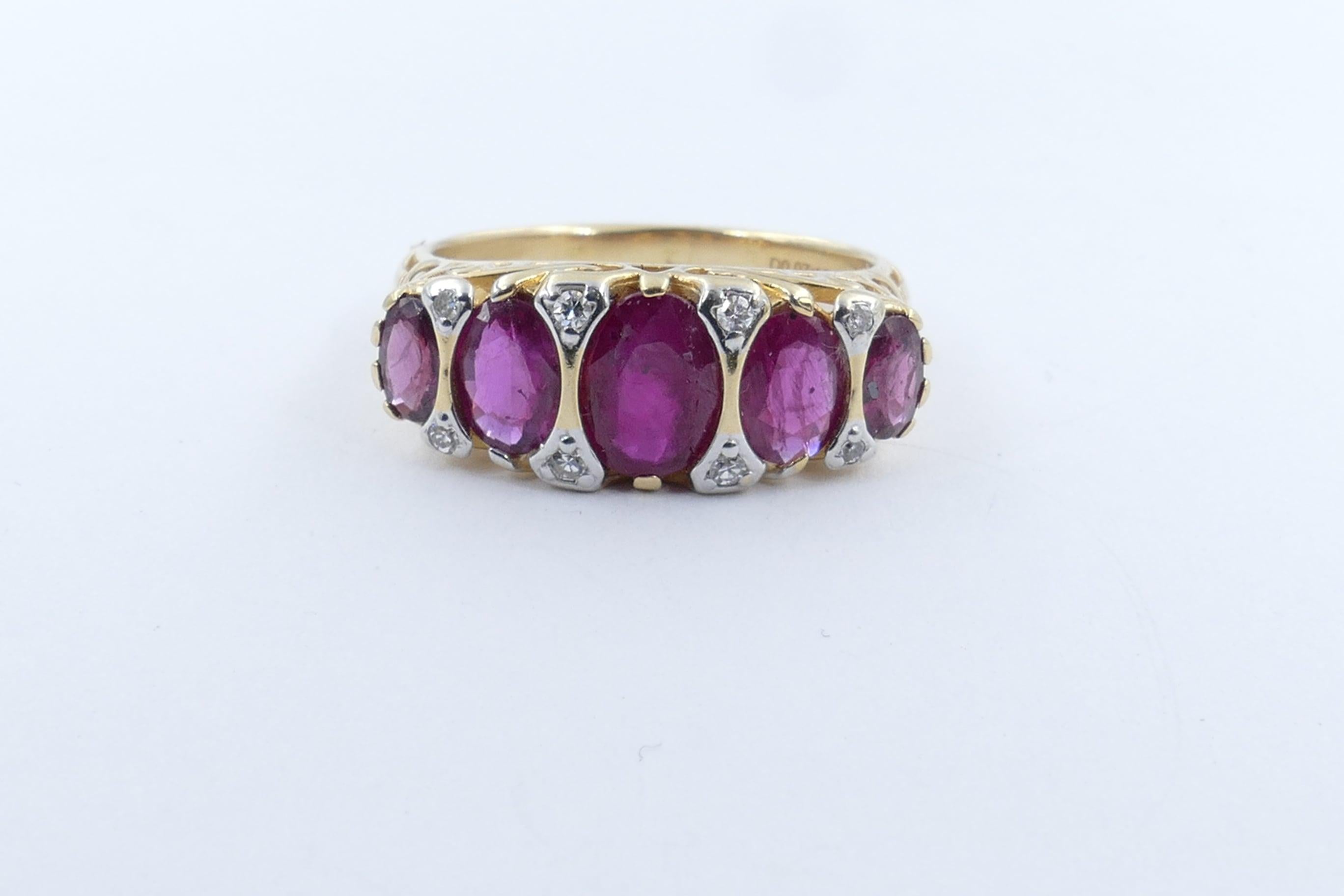 5 Good Rubies Totalling 2.27 carats in weight are the feature of this very attractive Ring. the colour is purplish red, tone medium dark, oval cut, claw/half bezel set, flanked by 8 round single cut diamonds, micro claw set in white gold, colour