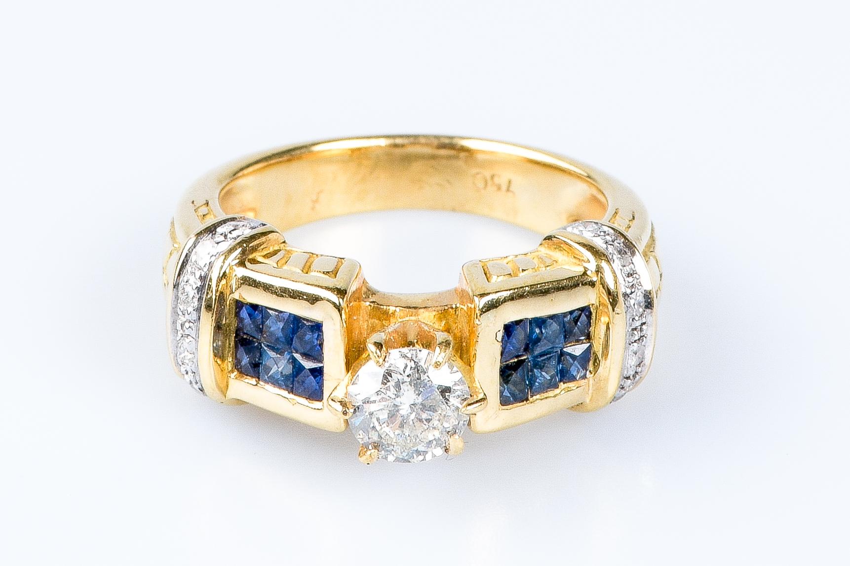 18 carat yellow gold ring designed with 1 round brillant cut diamond weighing 0.40 carats, 12 baguette cut sapphires weighing 0.24 carats and 12 round brillant cut diamonds weighing 0.12 carats.

Quality of the diamond
Color : H
Clarity : SI

