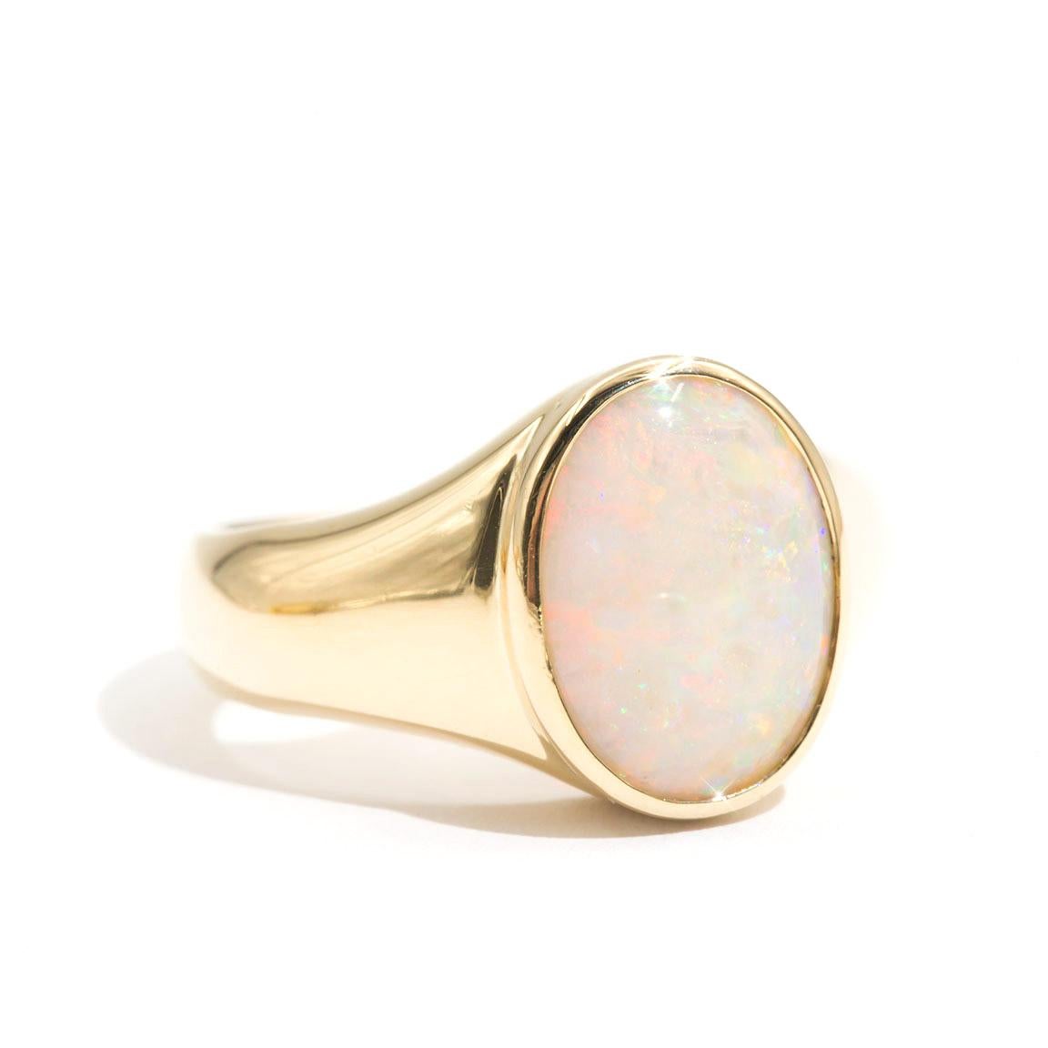Forged in 18 carat yellow gold is this handsome mens solitaire signet ring that features an enchanting solid Australian opal.  We have named this dapper vintage ring The Mayfair Ring. The Mayfair Ring has smooth, curved lines and flows to a domed