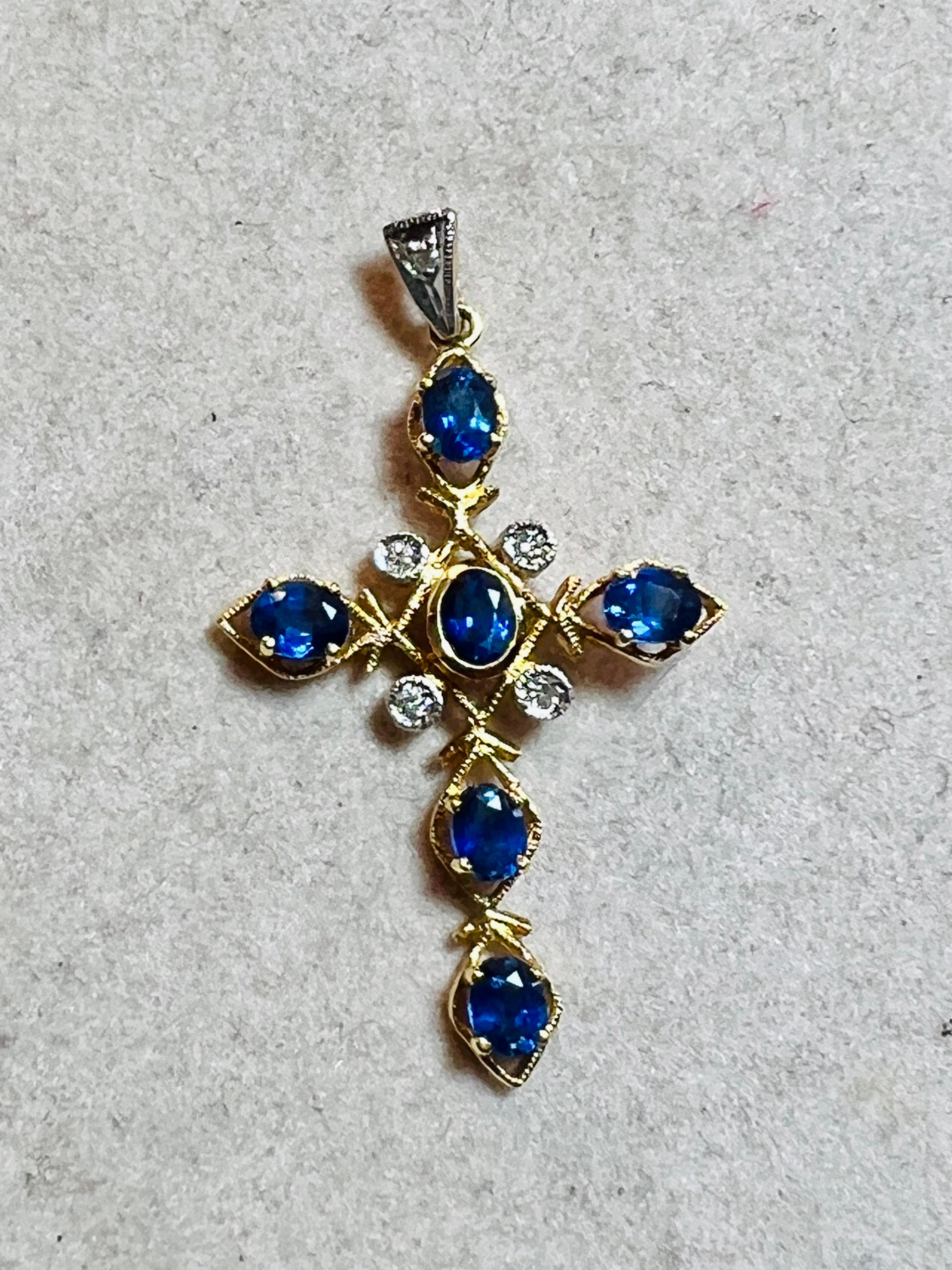 18 carat yellow gold vintage cross 
set with approximately 1.28 carat sapphires 
and 0.07 carat of brilliants
 total weight: 2.41 g 
length: 3.8 centimeters
width: 2.3 cm