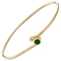 18 Carat Yellow Gold Wire Bangle Bezel Set with a 0.25 Carat Round Emerald 