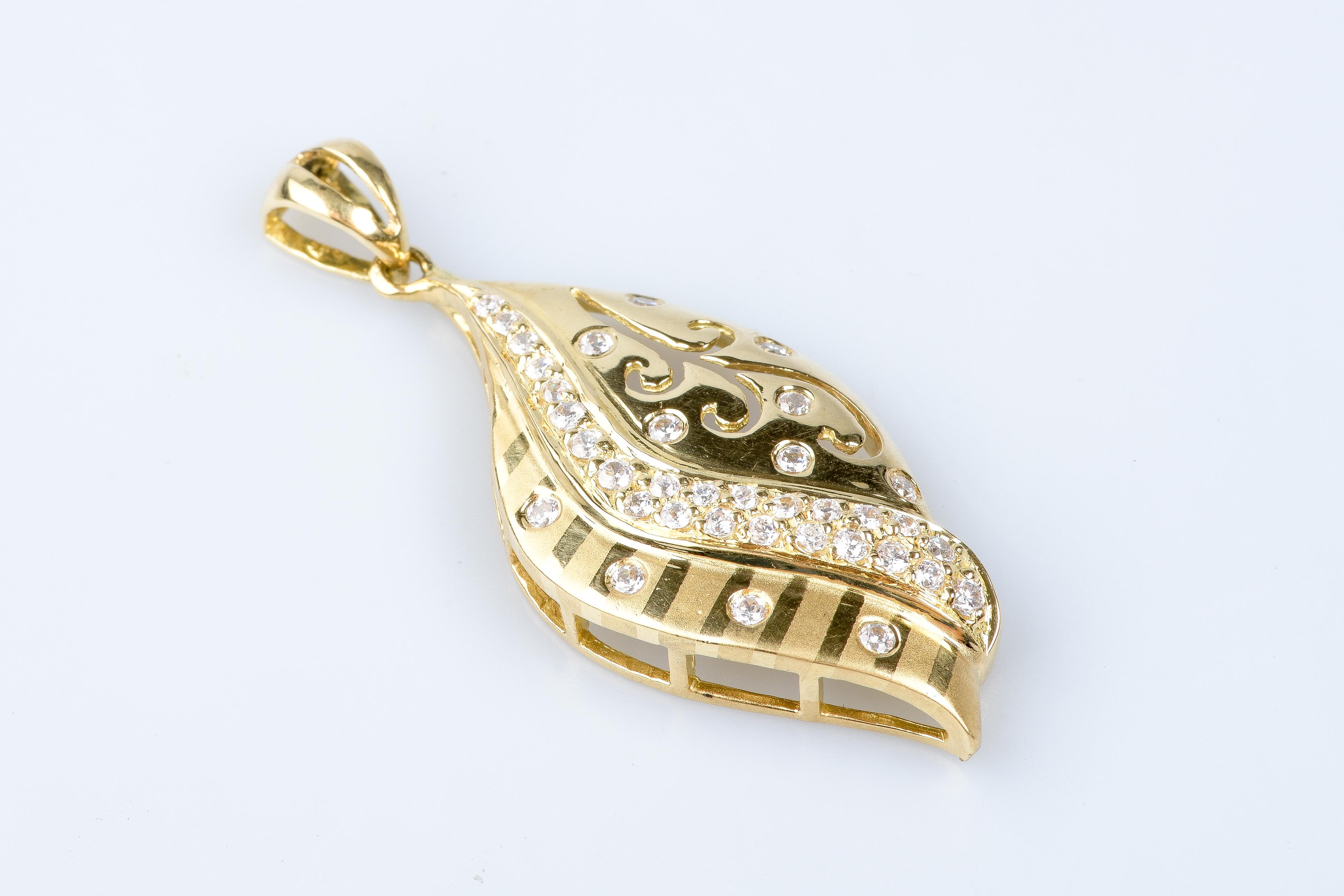 18 carat yellow gold pendant designed with zirconium oxides.

 Weight : 7.90 gr. 

Dimensions : 4.80 x 2.00 x 0.76 cm

Jewel delivered in a luxurious box with a certificate of authenticity Monte-Carlo Bijoux. 

Condition : Like new

18 carat gold