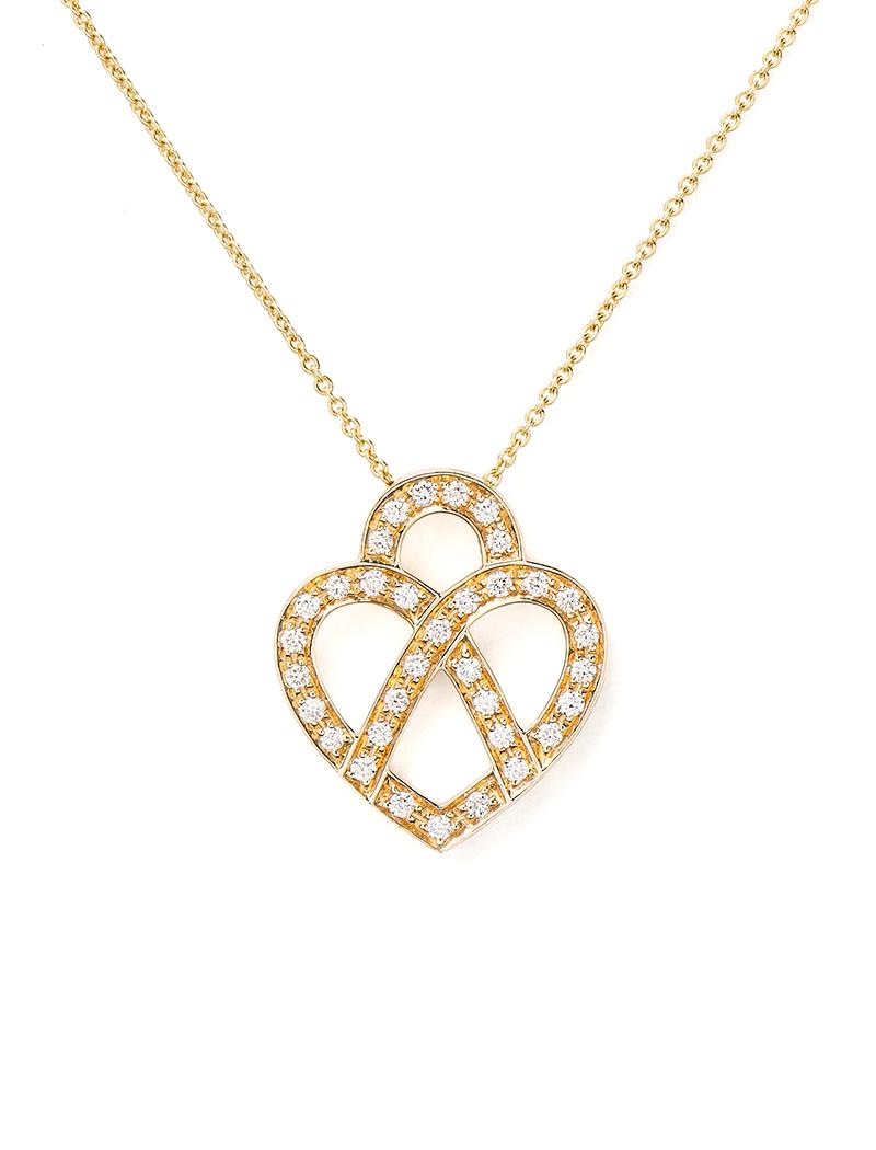 The timeless Poiray collection Cœur Entrelacé is revealed in pure lines, with generous curves, and is dressed in gold or diamonds to celebrate all loves.

Cœur Entrelacé necklace, small model in yellow gold paved with diamonds.

Diamond - 0.15 carat
